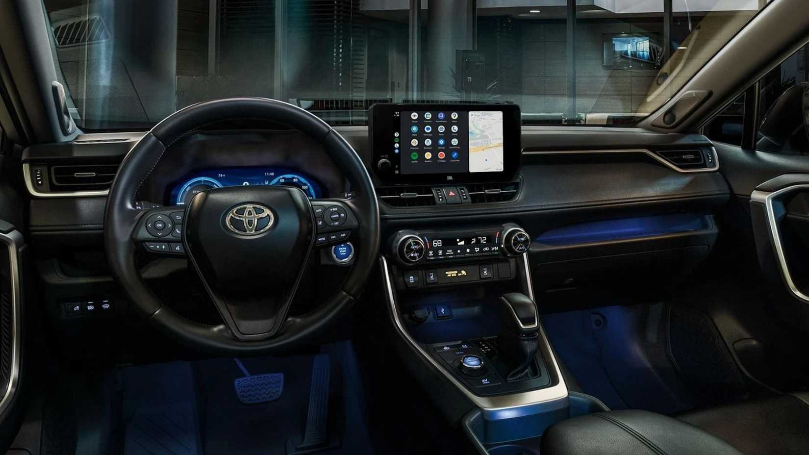 Close-up shot of the dashboard of a 2024 Toyota RAV4 at night with its ambient lighting.
