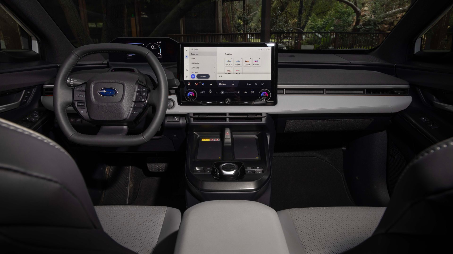 Close-up shot of the dashboard of the 2026 Subaru Solterra showing the steering wheel and infotainment screen.