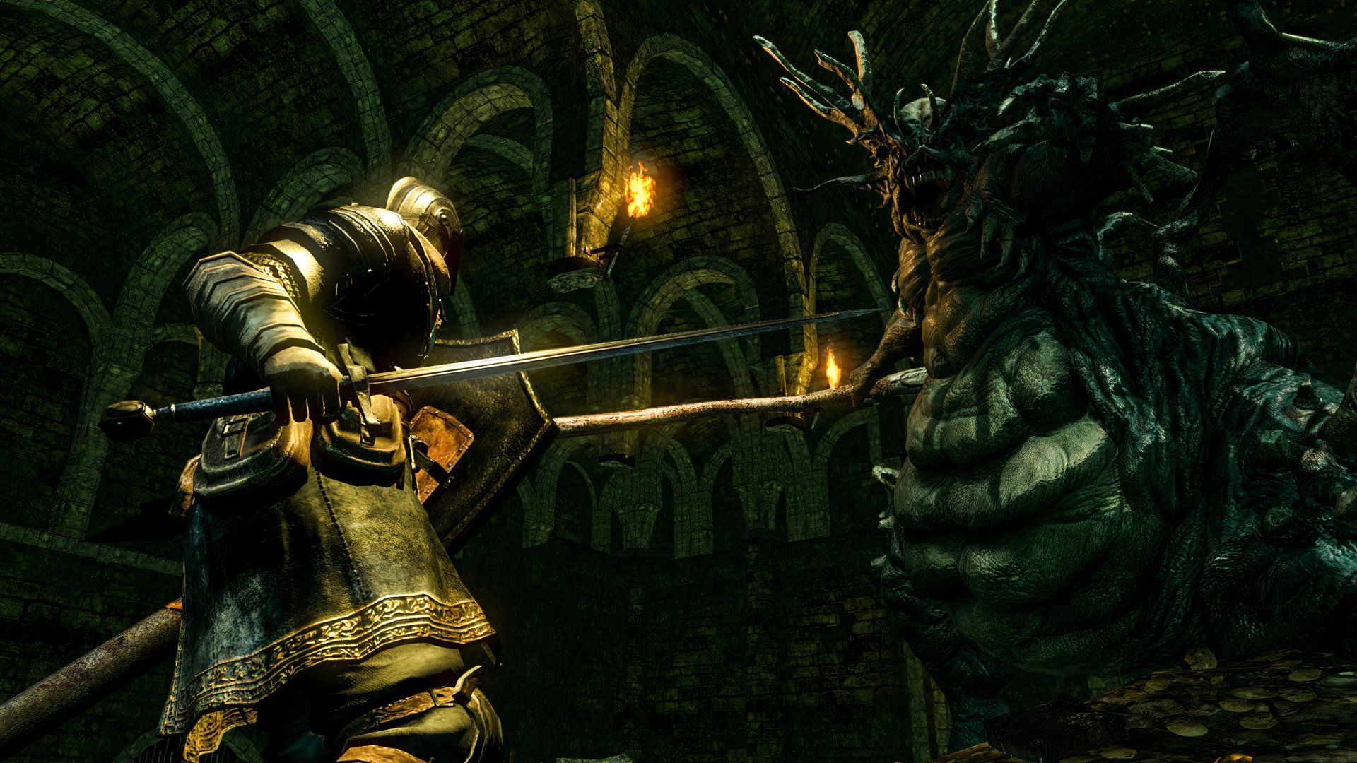The player battling a boss in Dark Souls.