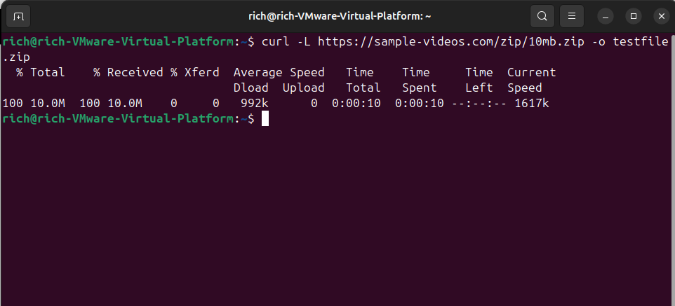 Terminal output showing the use of curl -L to download a 10MB ZIP file and save it as testfile.zip.