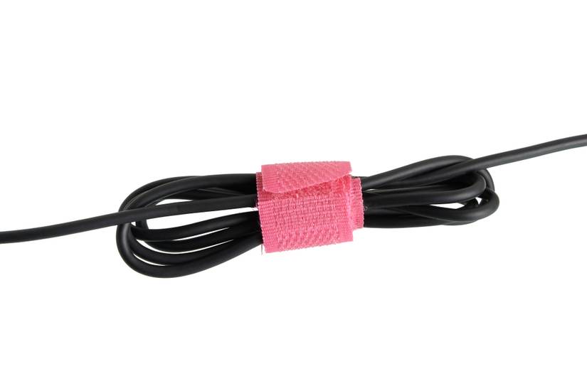 A pink Velcro cable tie around a cable.