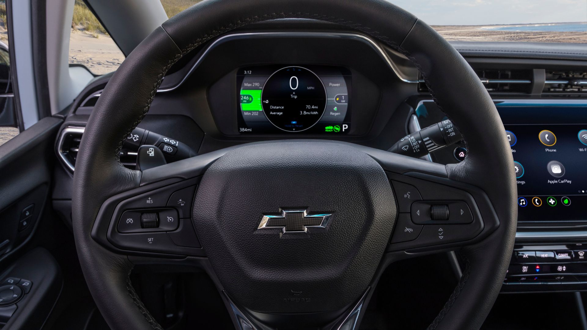 Close-up shot of the steering wheel in a 2022 Chevrolet Bolt EV, showing the digital instrument cluster and infotainment screen.