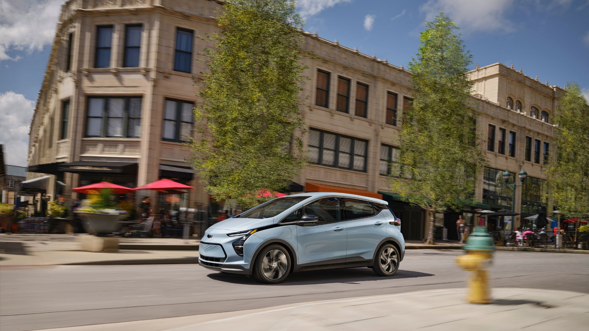 Dynamic Lateral profile phase of a 2023 2023 Chevrolet EV curler crossing a city.