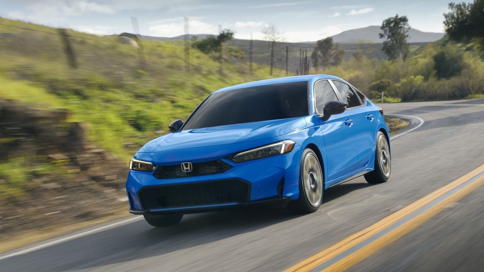 Front 3/4 action shot of a 2025 Honda Civic
