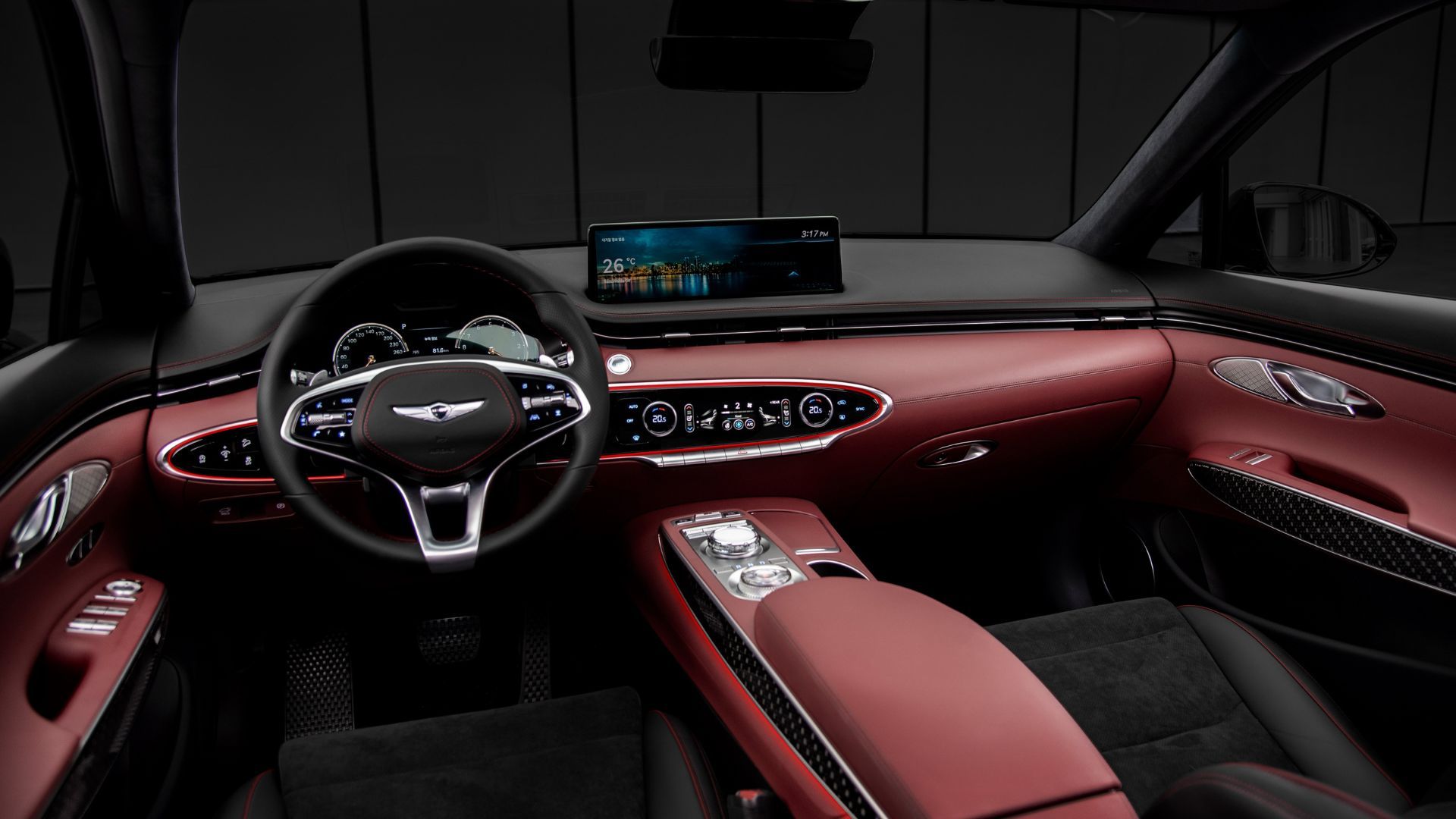 Close-up shot inside the cabin of a Genesis GV70, showing the front seats, center console, steering wheel, and infotainment screen.