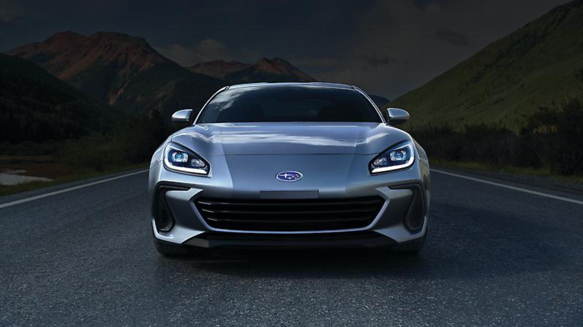 Static front-end shot of a silver 2024 Subaru BRZ parked in the middle of a road.