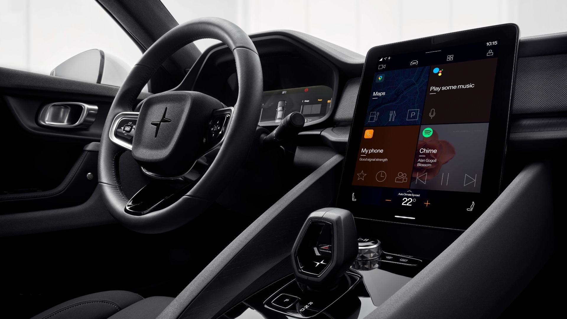Close-up shot of the steering wheel, infotainment screen, and gear selector in a 2023 Polestar 2.