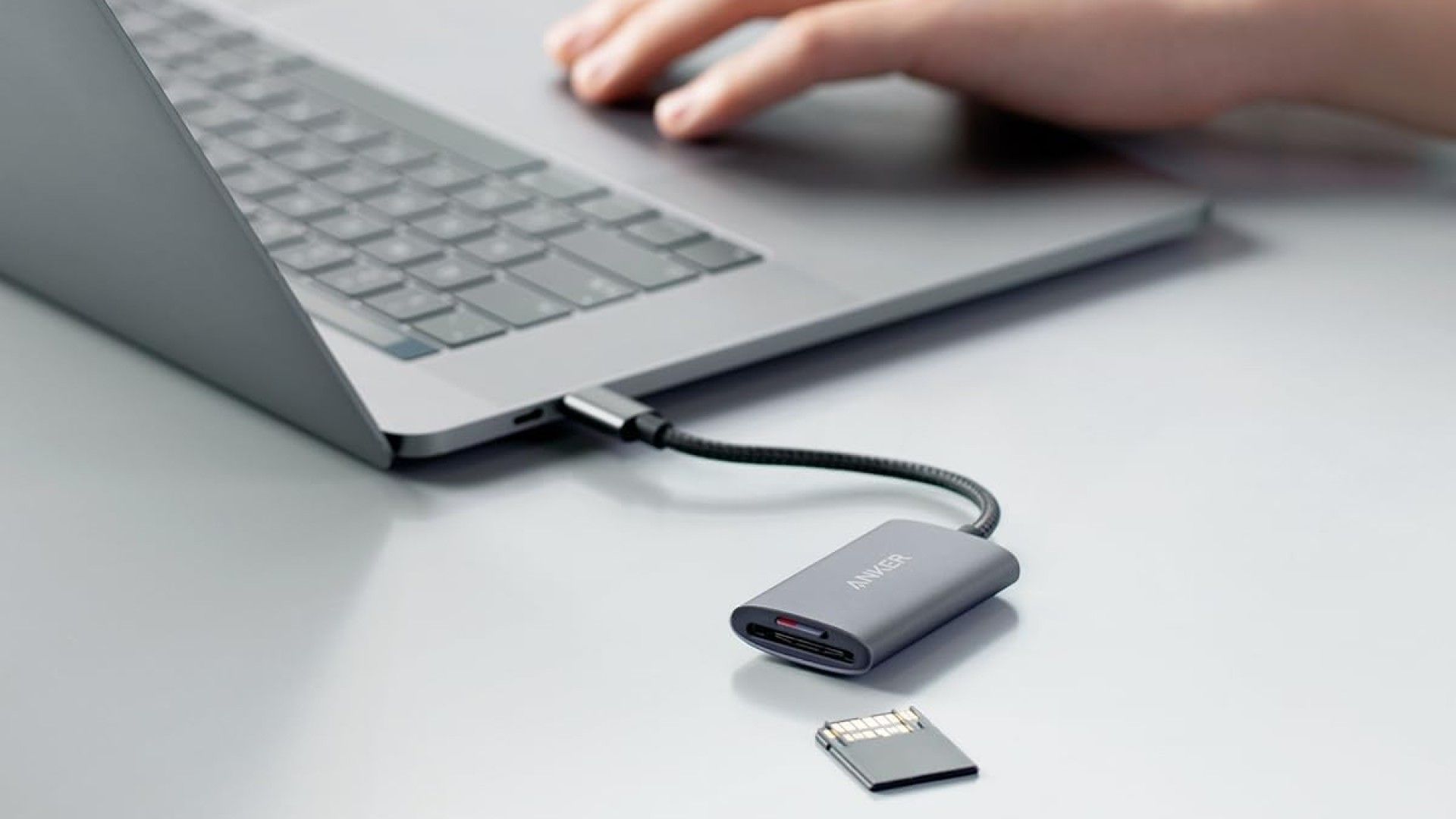 An Anker SD Card Reader connected to a laptop.