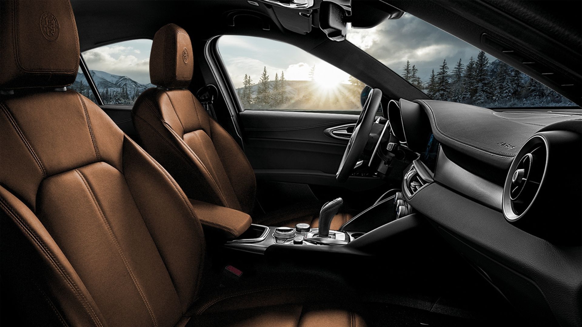 Close-up shot inside the cabin of a 2022 Alfa Romeo Giulia, showing the front seats, steering wheel, and center console.