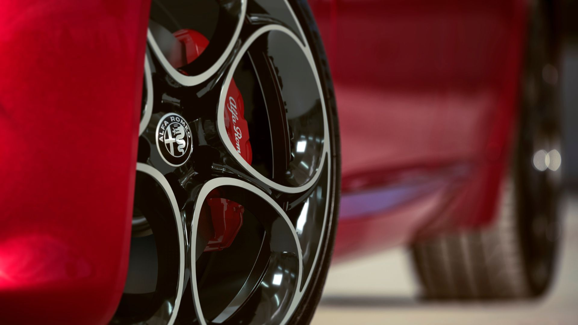 Close-up shot of the alloy wheel on a red 2022 Alfa Romeo Giulia.