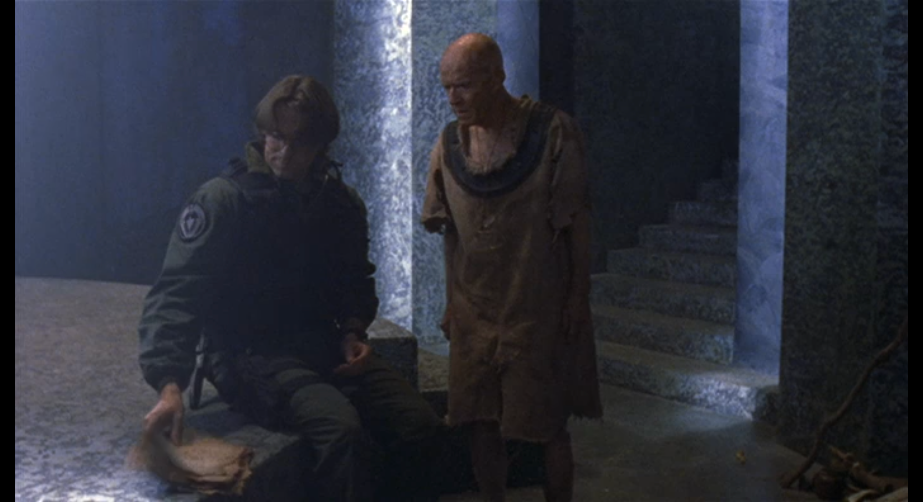 Jackson and the old man look at his notes in Stargate SG-1.