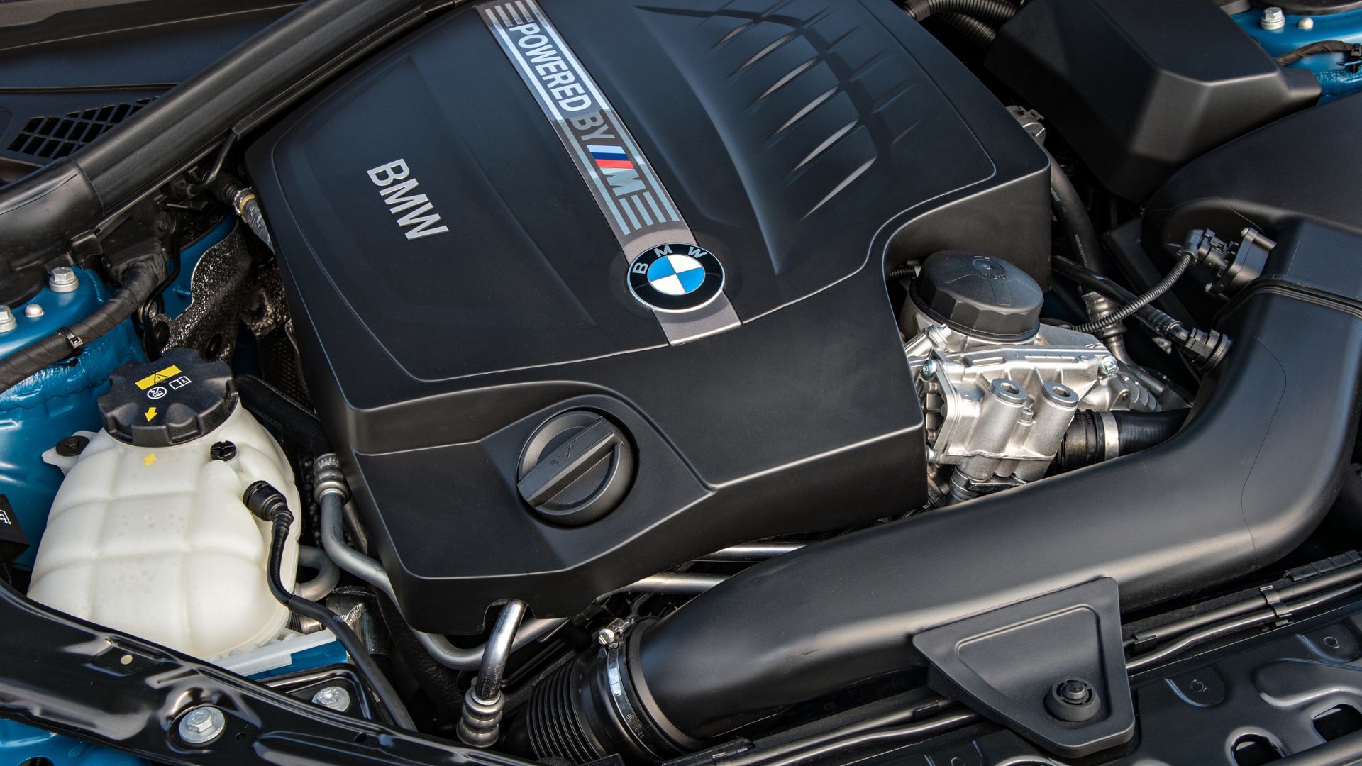 Close-up shot of the engine bay of a 2016 BMW M2.