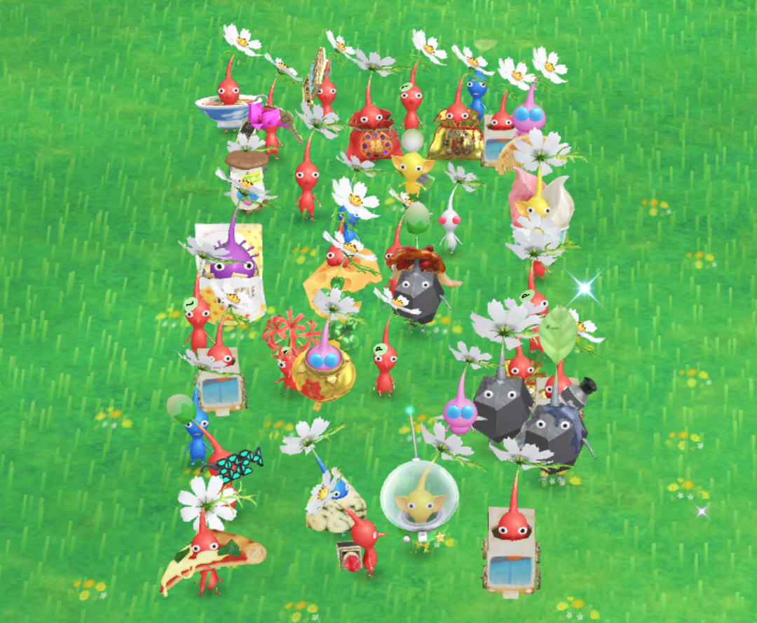 A group of Pikmin looking at the camera. Many have individual decor attached and most have a flower petal sprouting from the top of their heads.