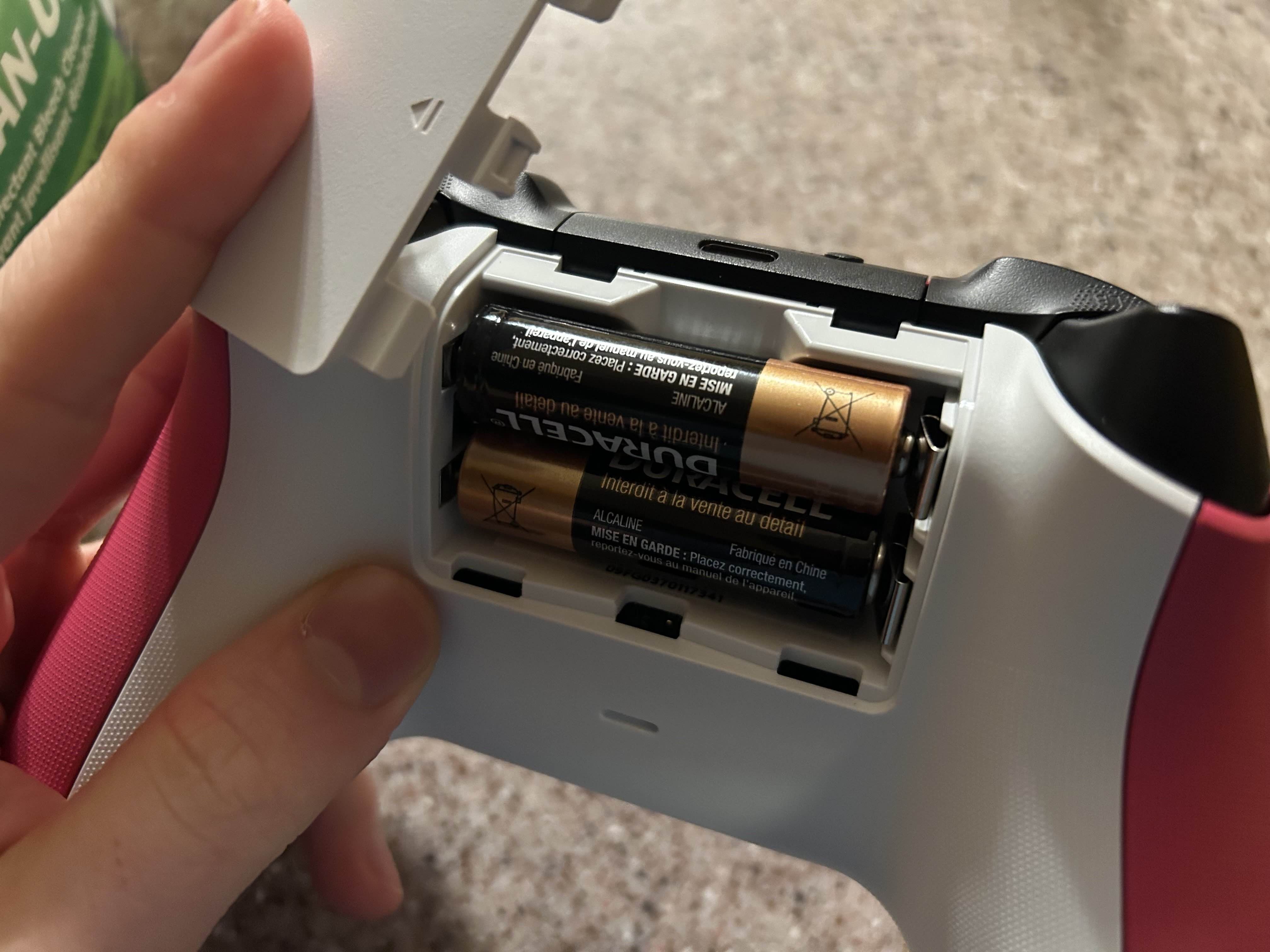 The opening of the battery compartment of a Pink Xbox One Controller.