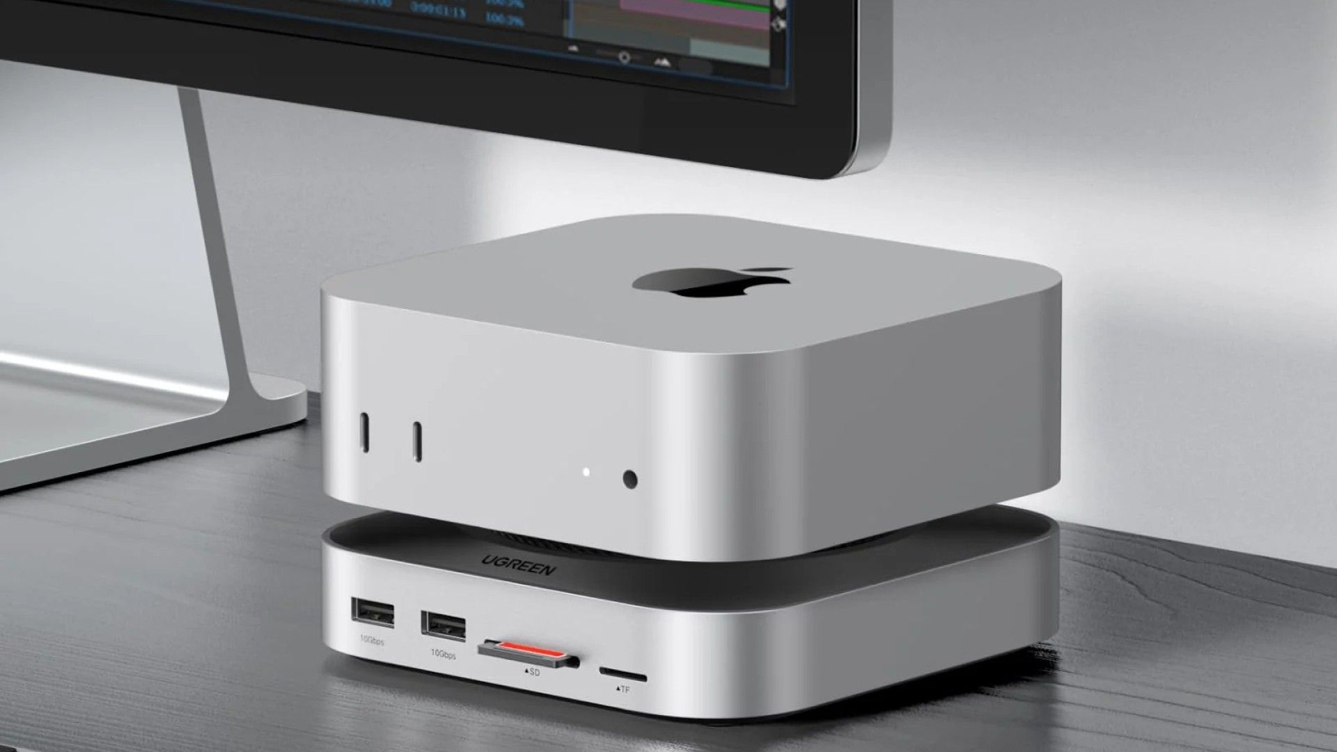 A UGREEN M4 Mac Mini Dock sitting on a desk.