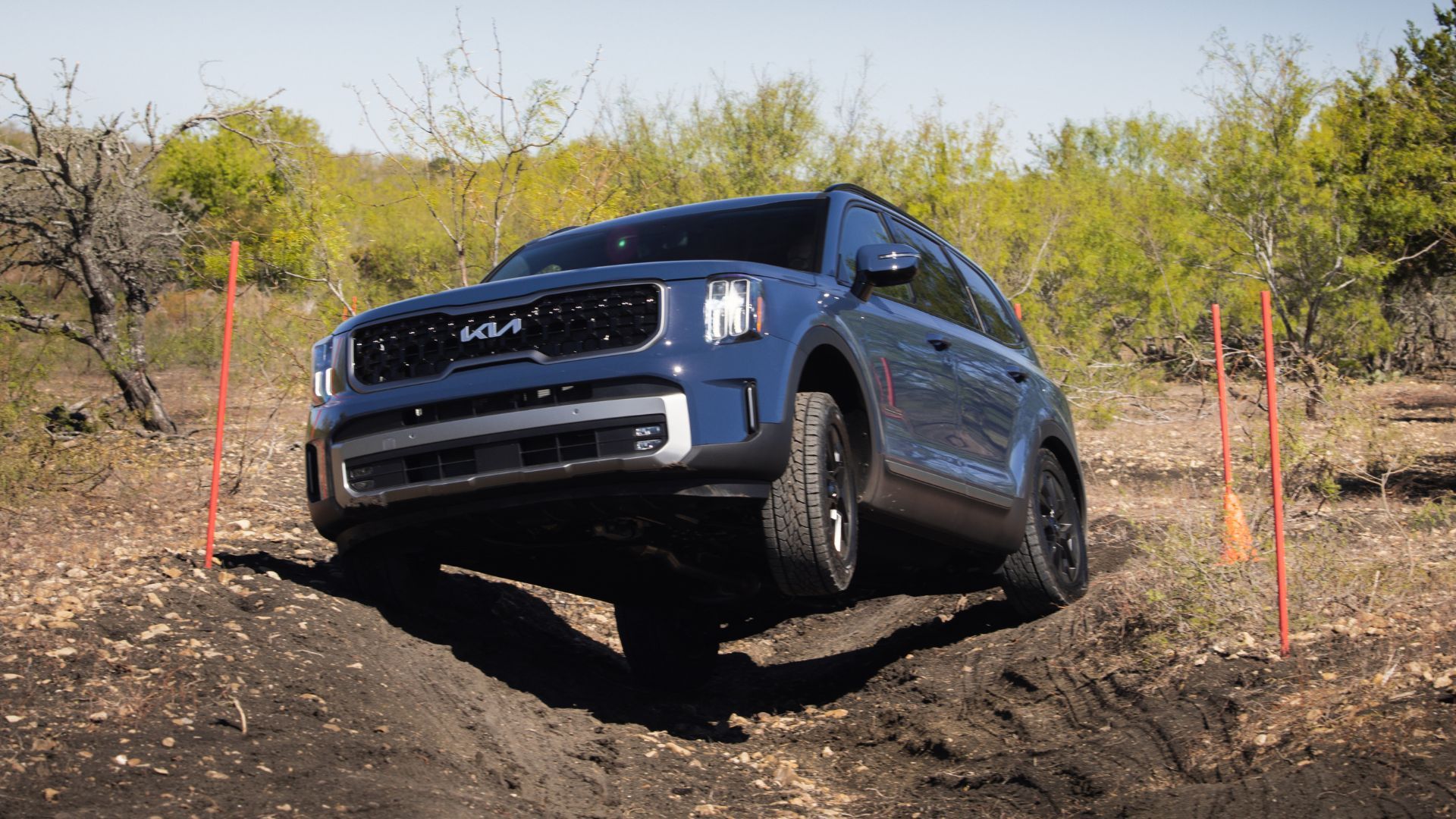 Dynamic front 3/4 shot of a blue 2023 Kia Telluride off-roading.