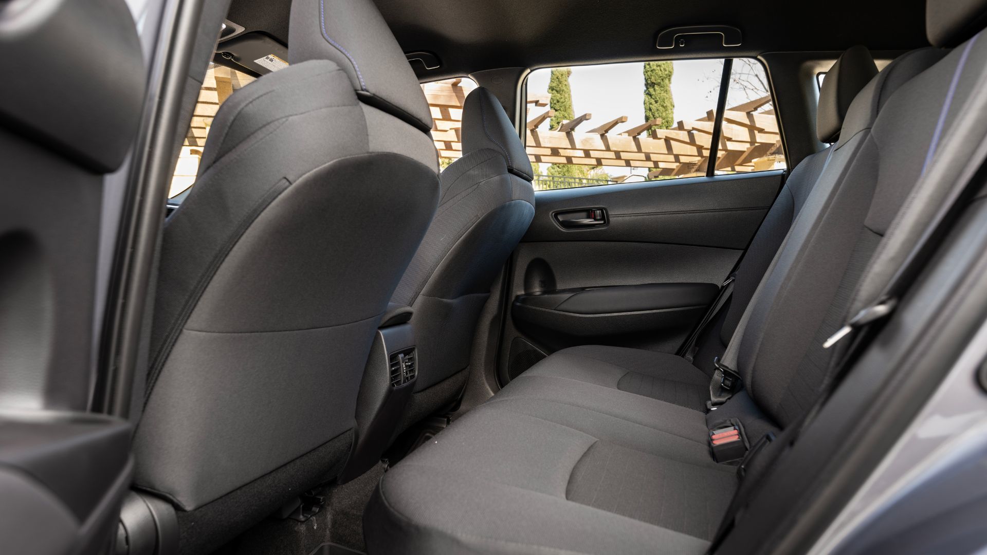 The shot signs a 2023 Toyota Corolla Cross Hybrid SK cabin, showing the back seats.