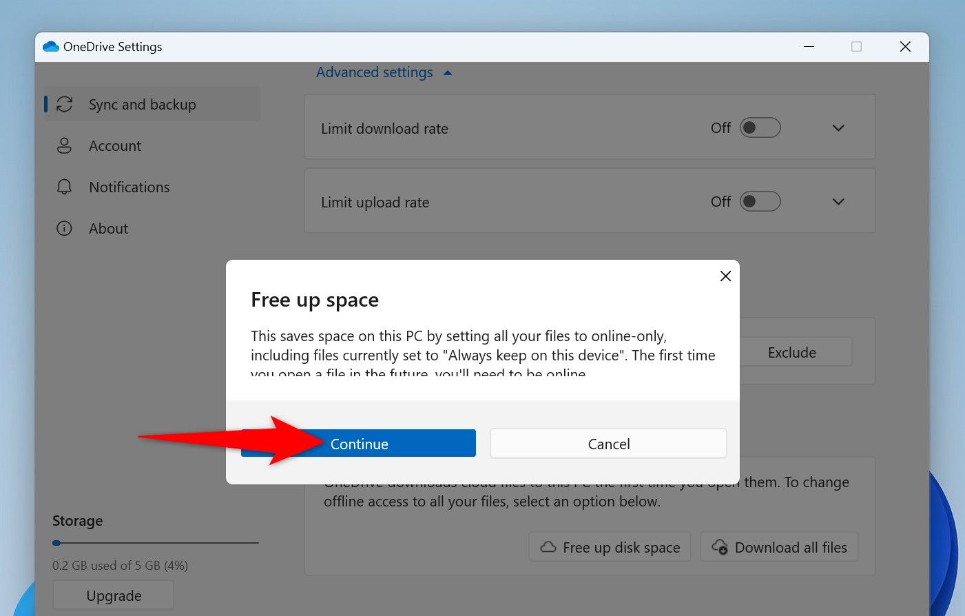 "Continue" highlighted in OneDrive's "Free Up Space" prompt.