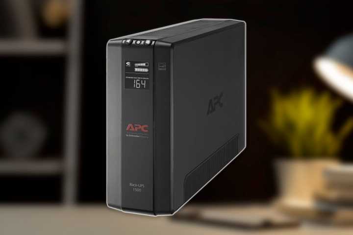 The APC 1500VA UPS over a photo of an office.