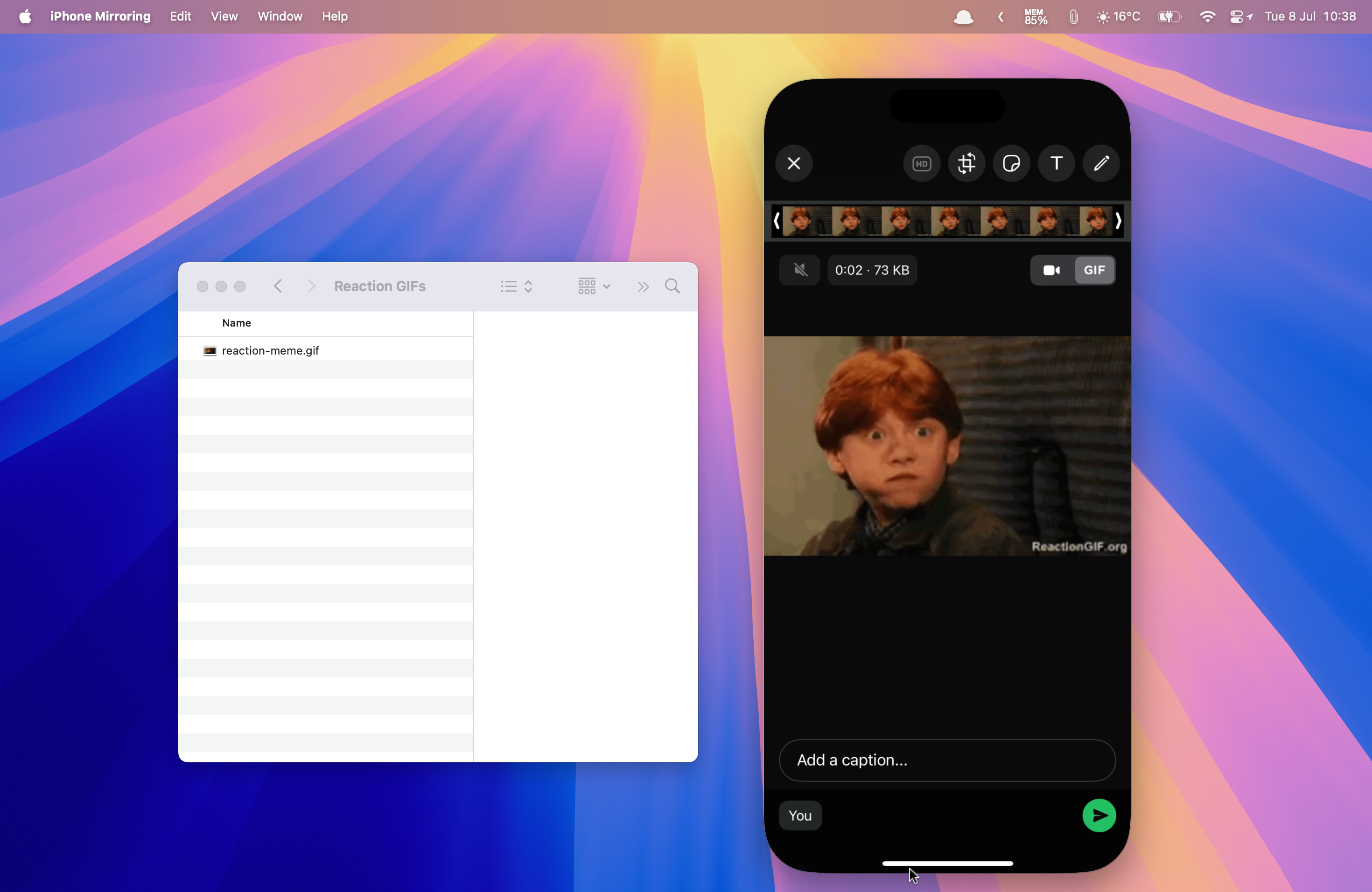 A reaction GIF dropped from a Mac desktop folder into the WhatsApp mobile app running in iPhone Mirroring on a Mac.