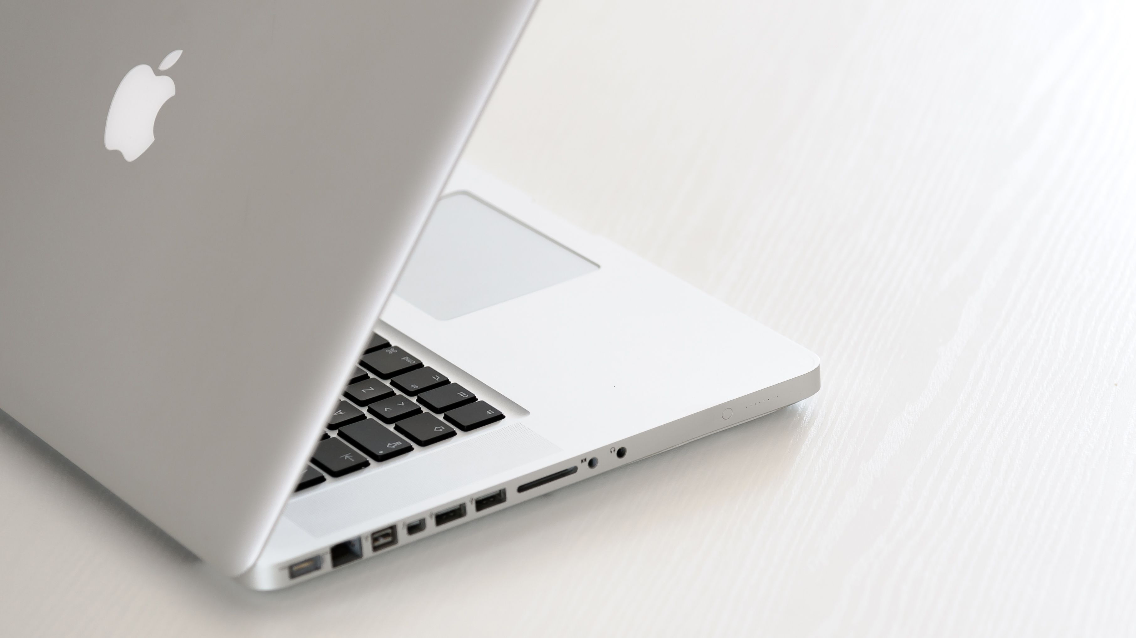 An old-style pre-Retina MacBook Pro with an optical drive.