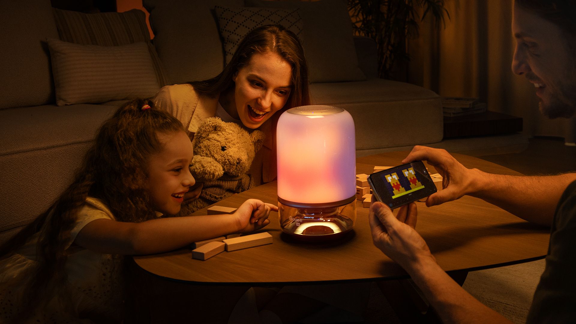 The Govee Table Lamp 2 Pro x Sound by JBL on a table surrounded by people.