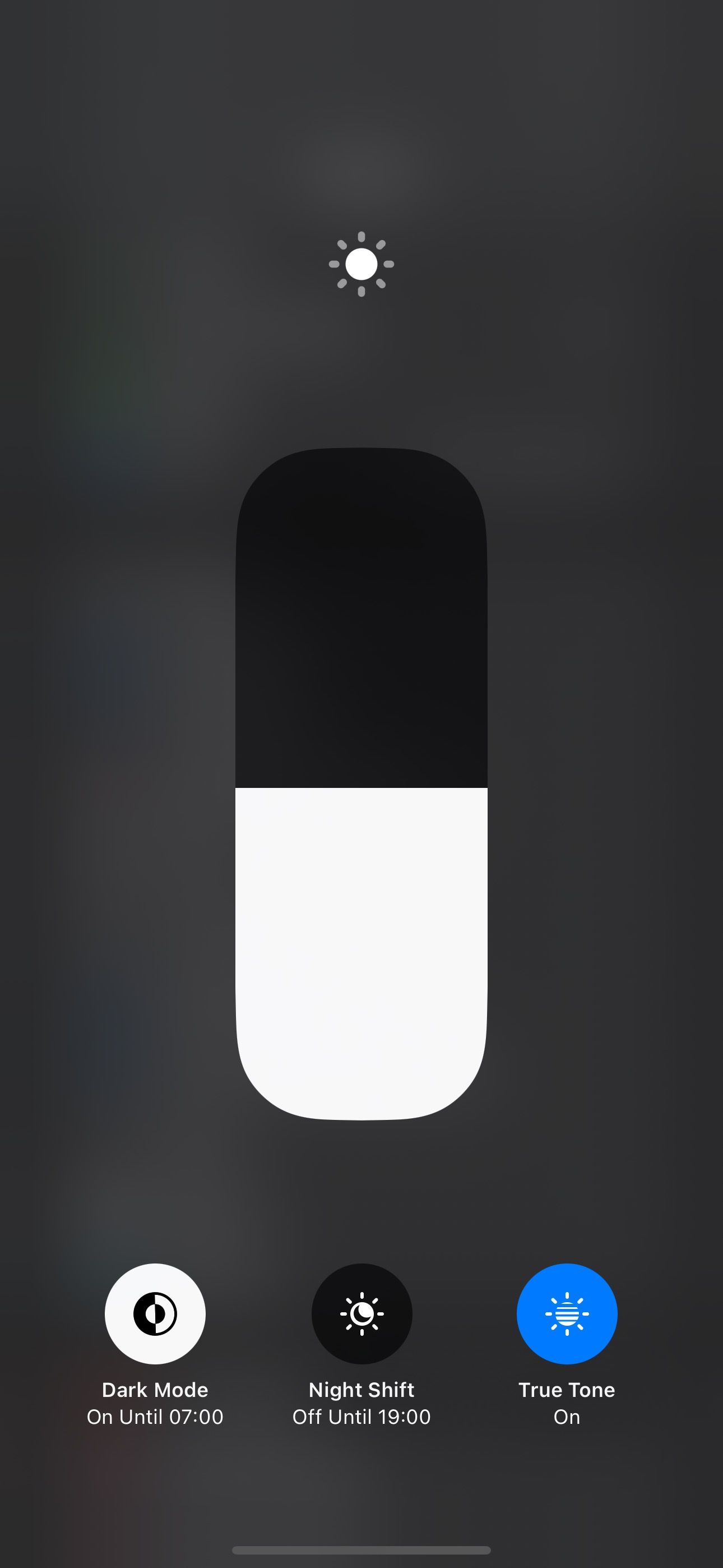 Dark Mode toggle turned on in Control Center on an iPhone.