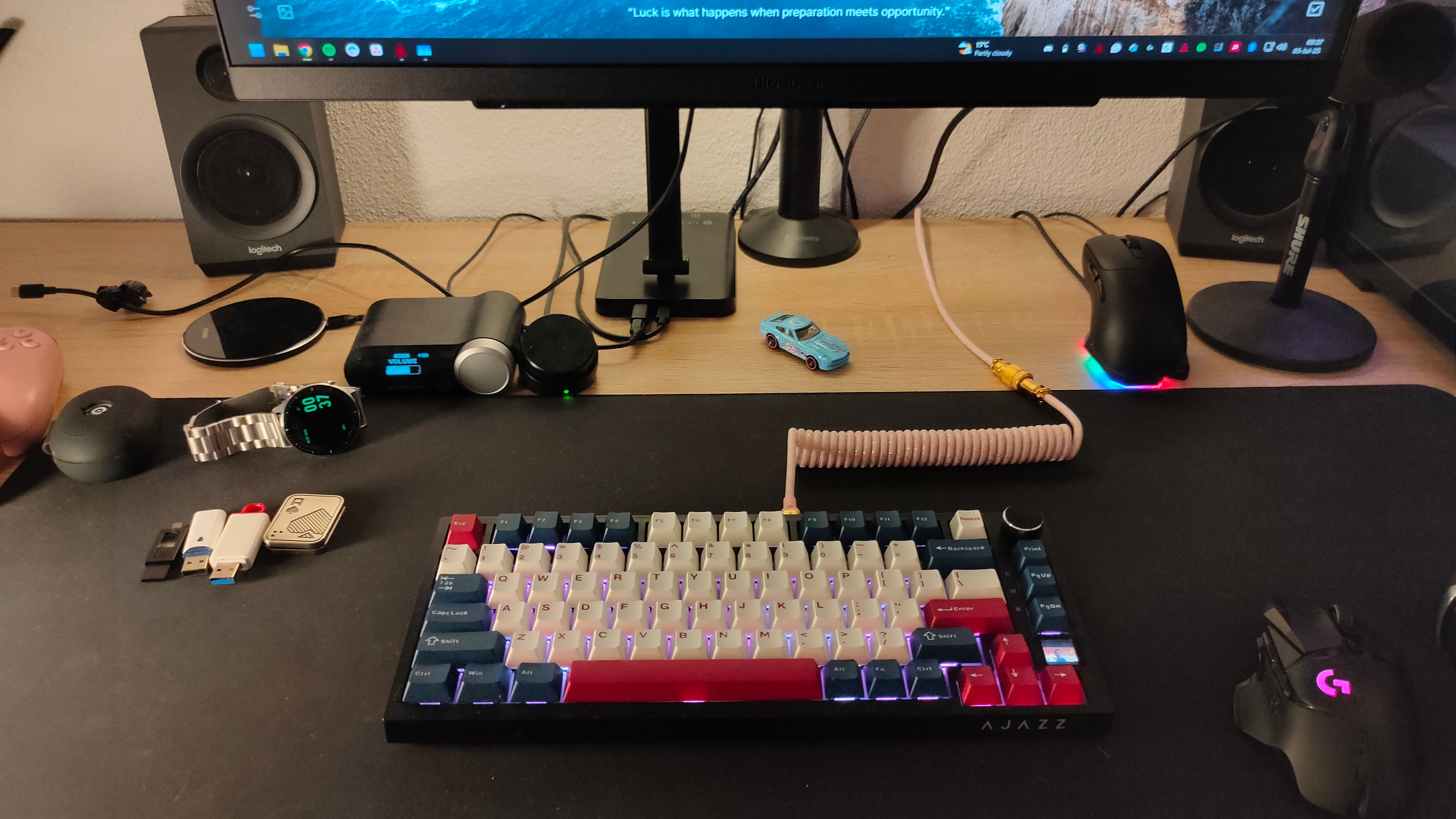 A computer desk with messy cables.