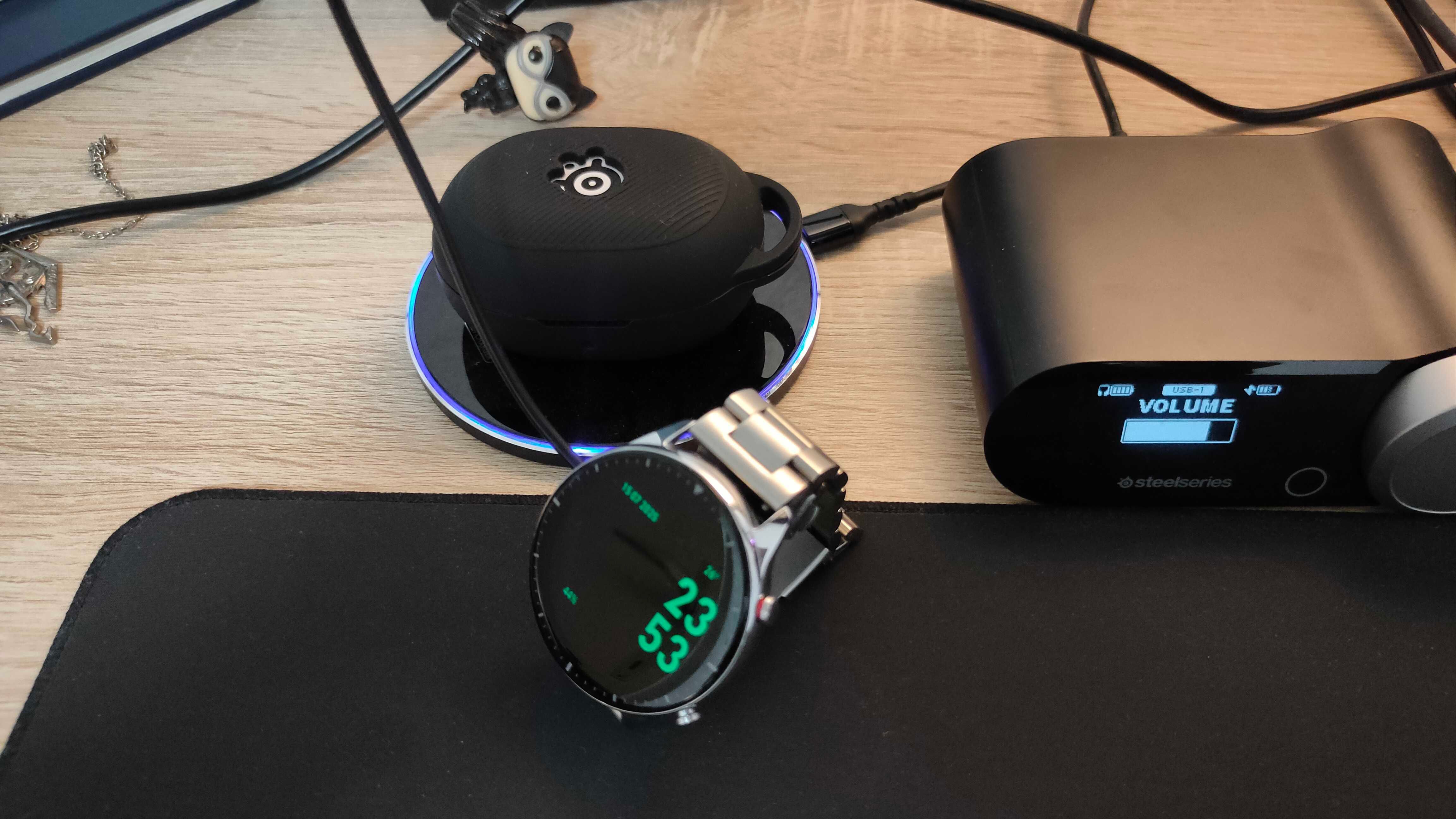 An Amazfit GTR 2 smartwatch and SteelSeries Arctis GameBuds charging.