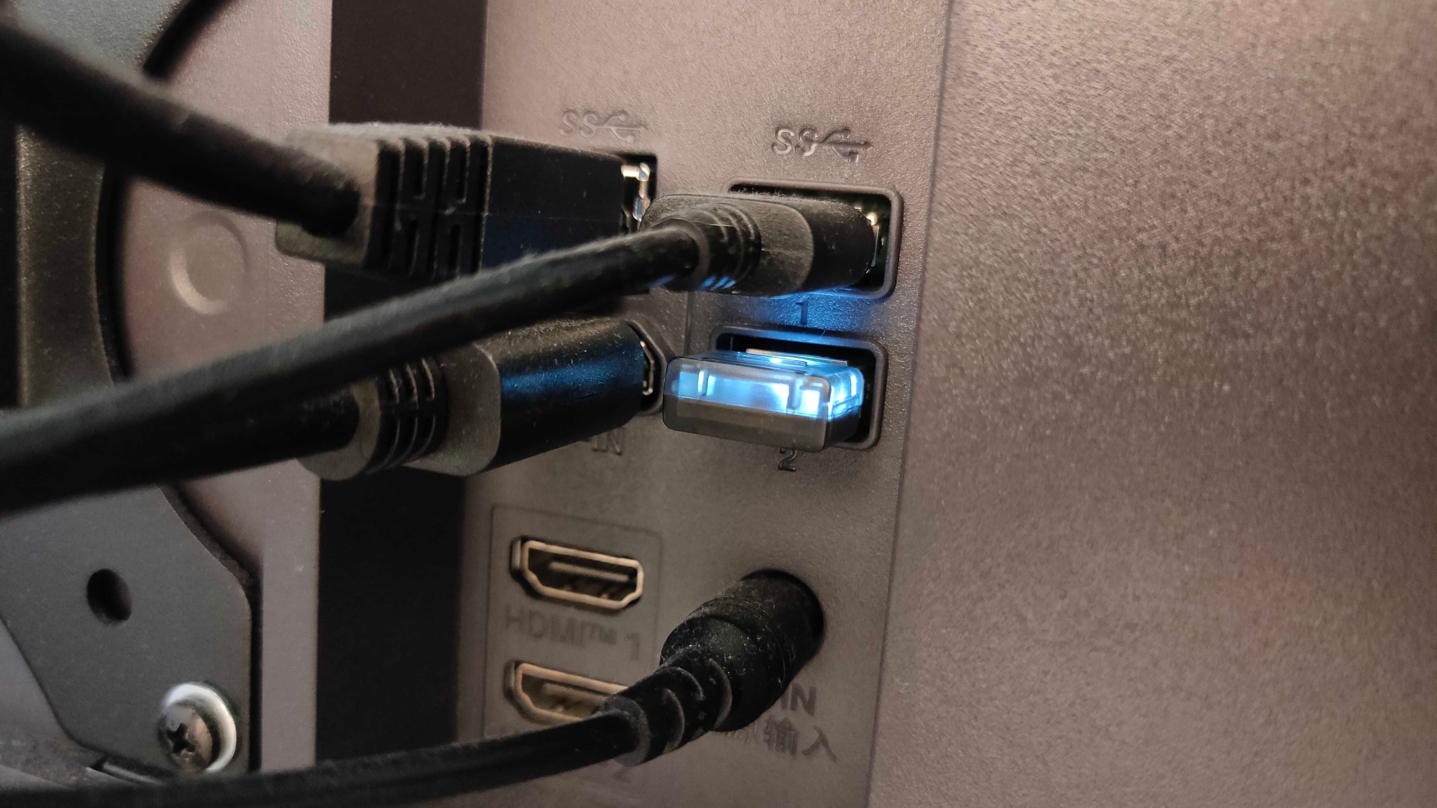 A 2.4GHz dongle plugged into a monitor.