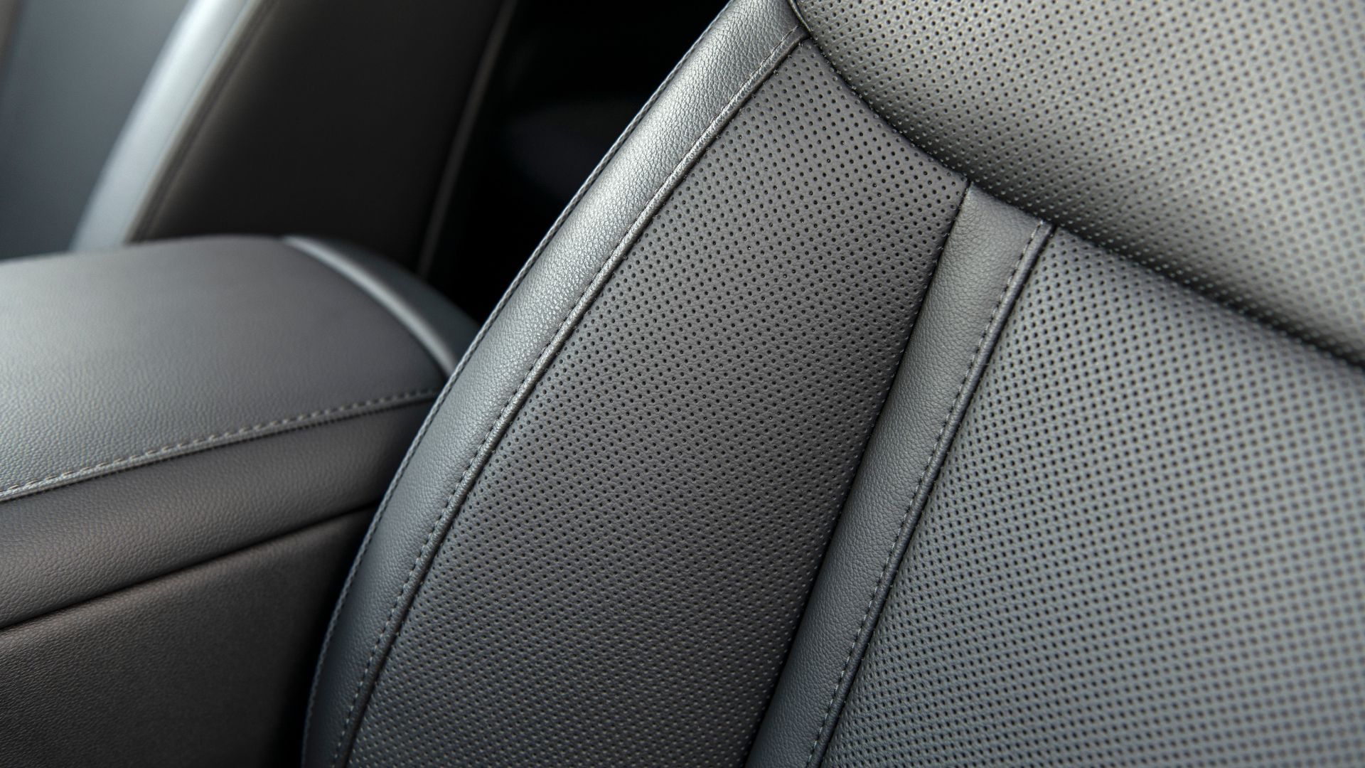 Close-up shot of black perforated leather seat in 2025 Hyundai Taxon Phev.