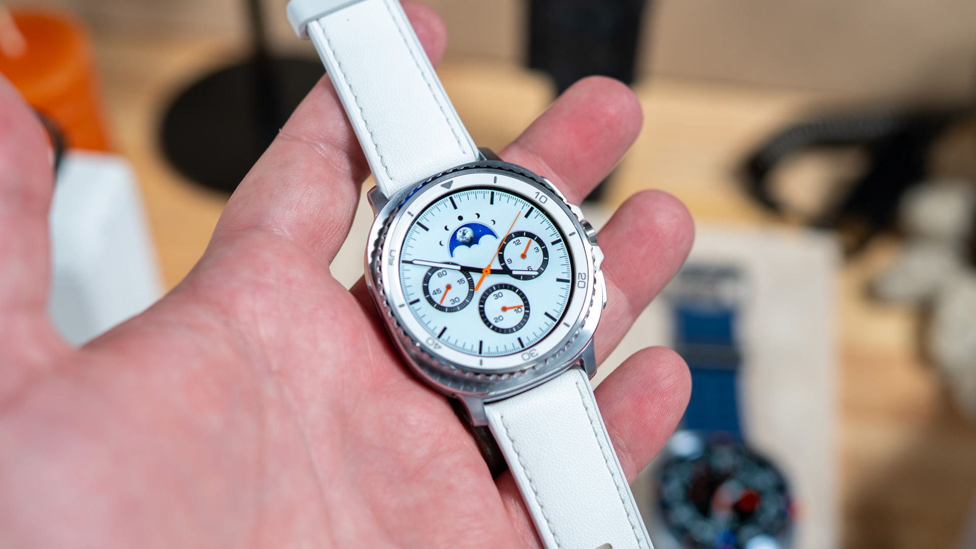 person holding the samsung galaxy watch 8 Classic.