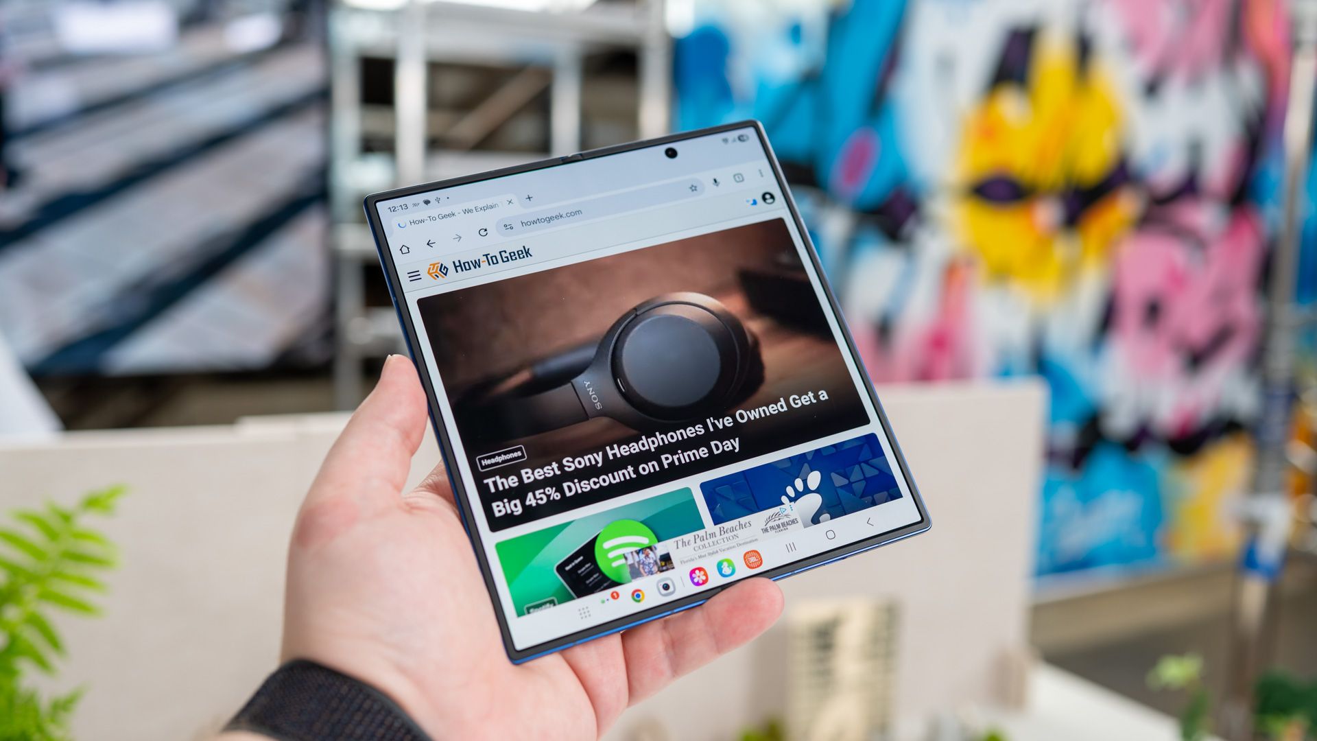 person holding the samsung galaxy z fold 7 unfolded showing the how to geek website 54642292833 o