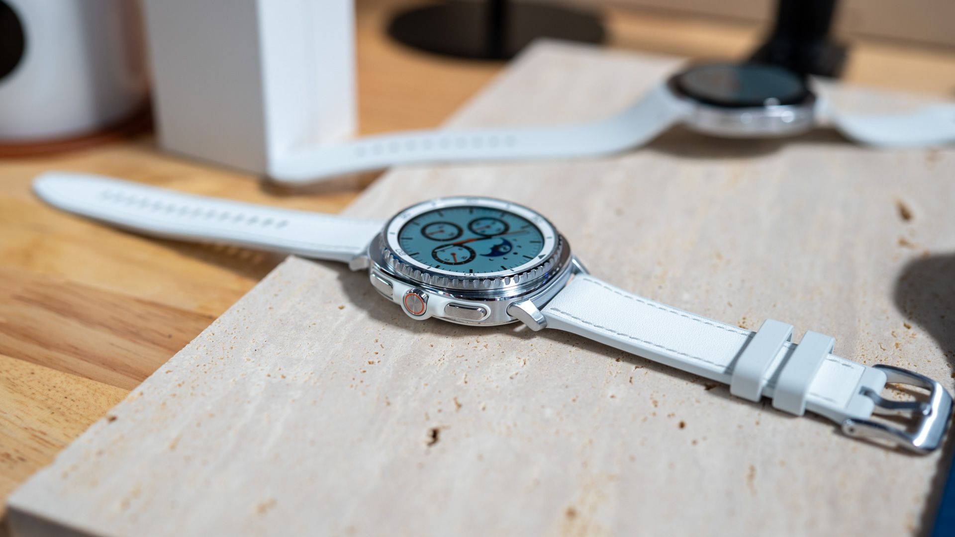 side profile of the samsung galaxy watch 8 classic laying on a table 54642278774 o-1