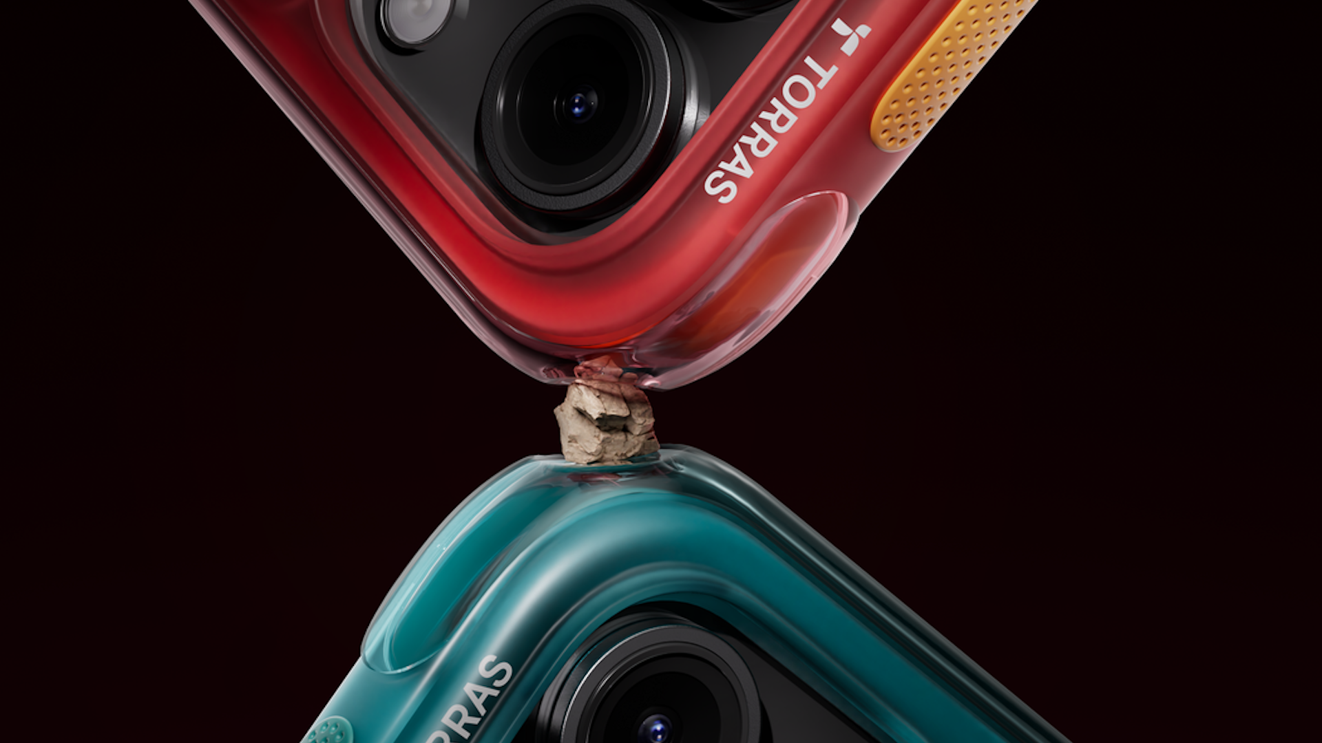 Two iPhones with a rock held between their corners.