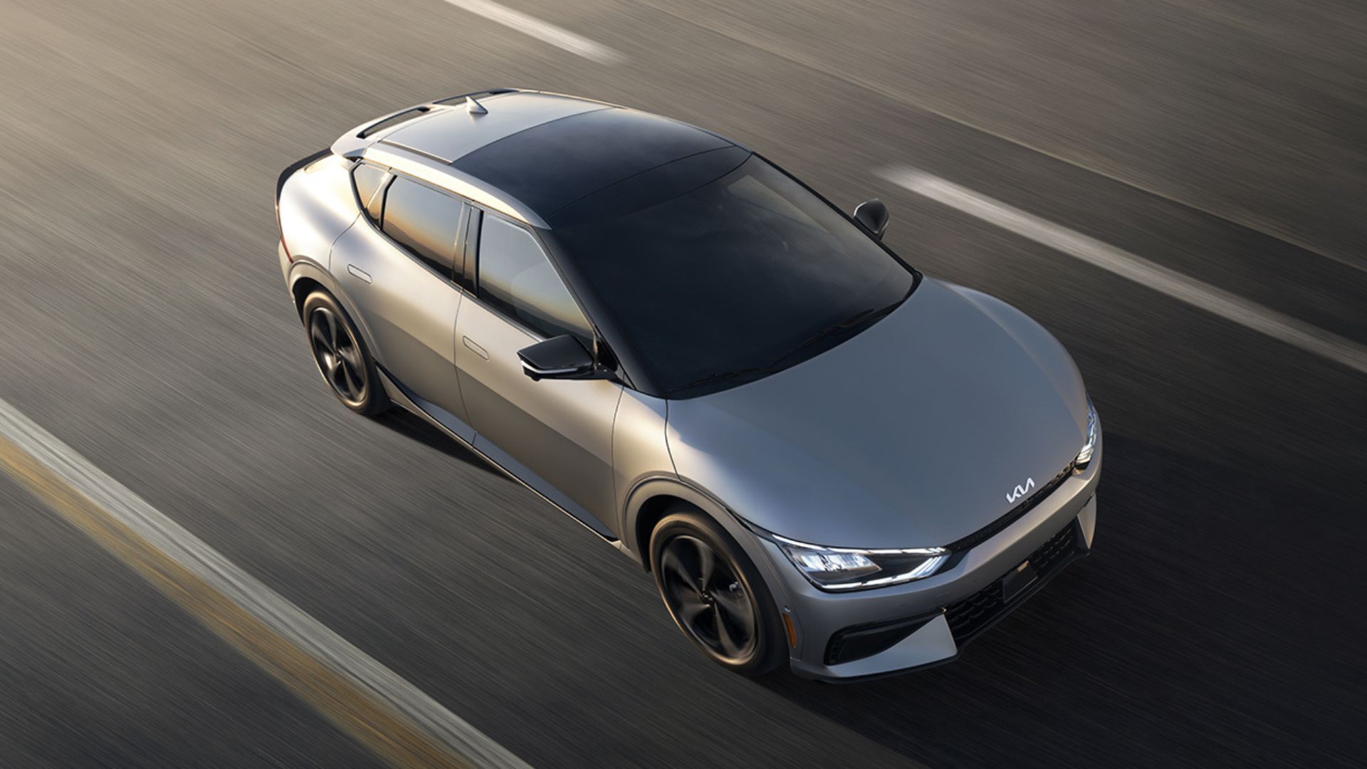 Dynamic overhead shot of a gray 2022 Kia EV6 driving on a road.