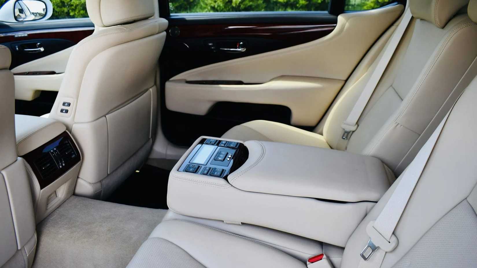 Shot inside the cabin of a 2011 Lexus LS 600h L showing the cream leather rear seats.