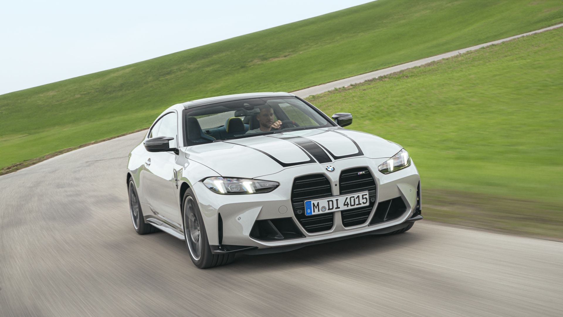 Front 3/4 action shot of a 2025 BMW M4