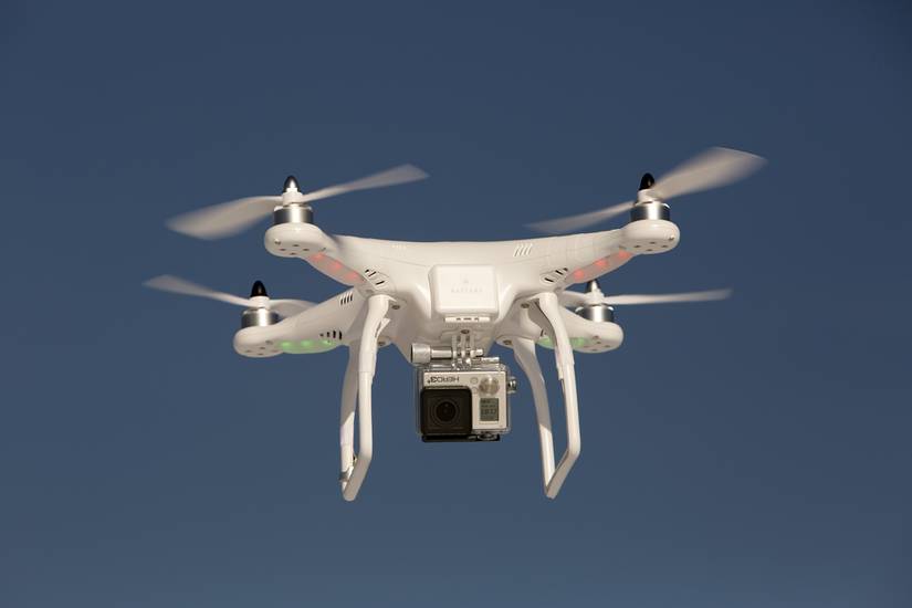 Editorial photo of a DJI Phantom drone in flight with a mounted GoPro Hero3+ Black Edition digital camera on.