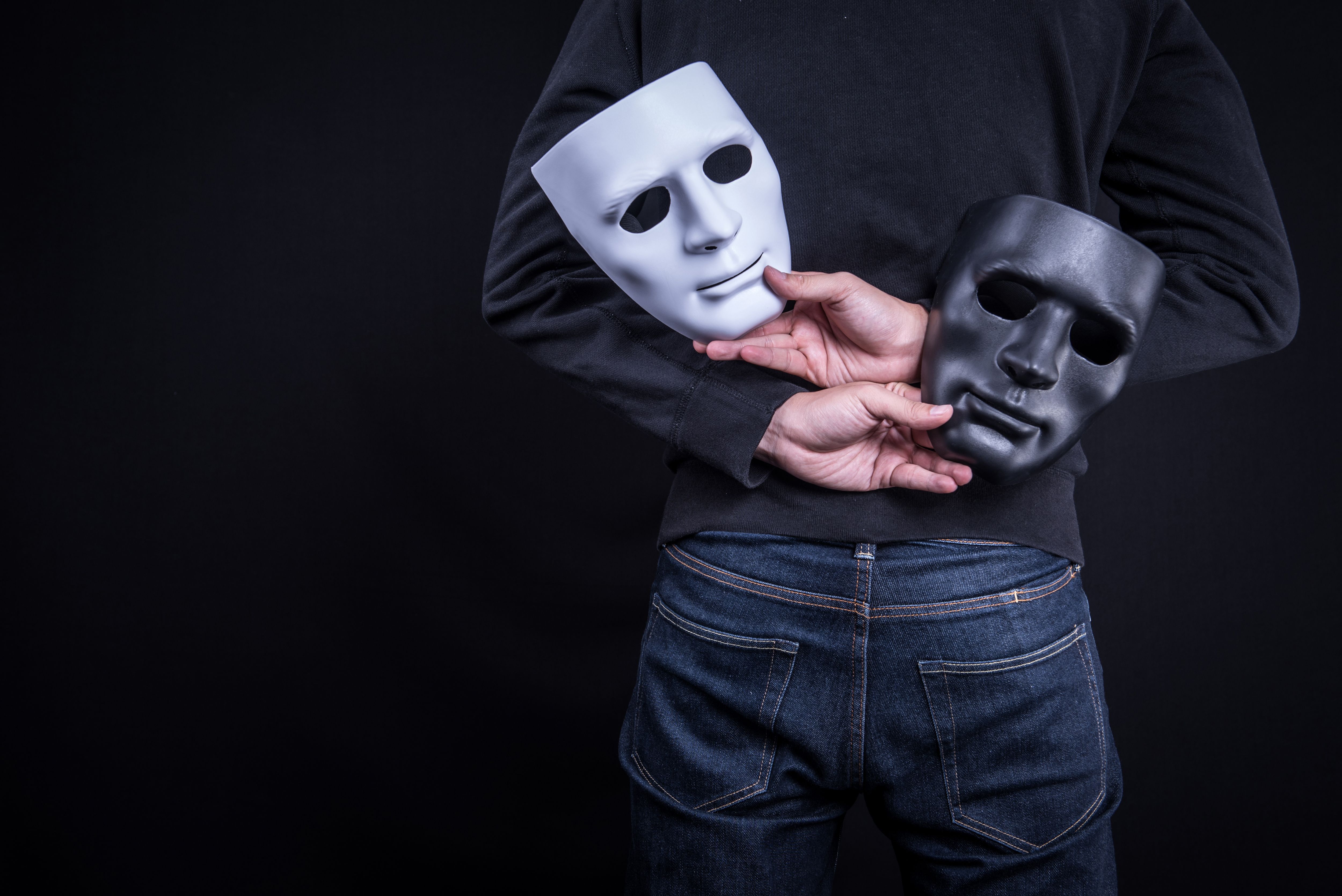 mystery man holding masks