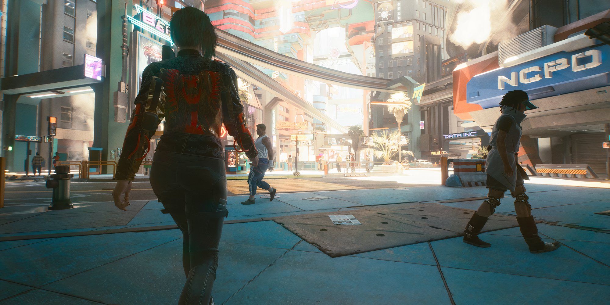 An over-the-shoulder shot of a character walking around Night City in Cyberpunk 2077