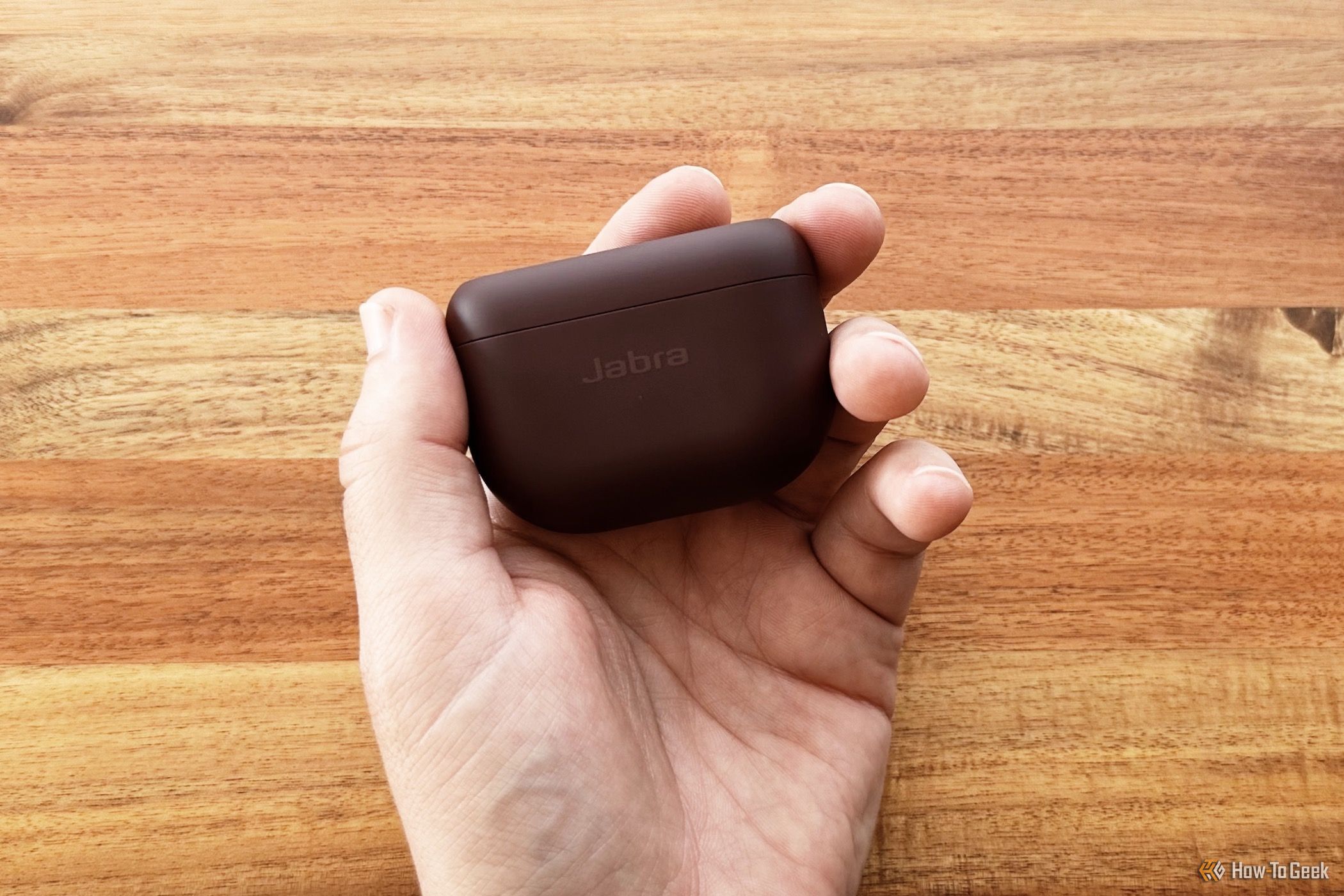 A hand holding the Jabra Elite 10 charging case
