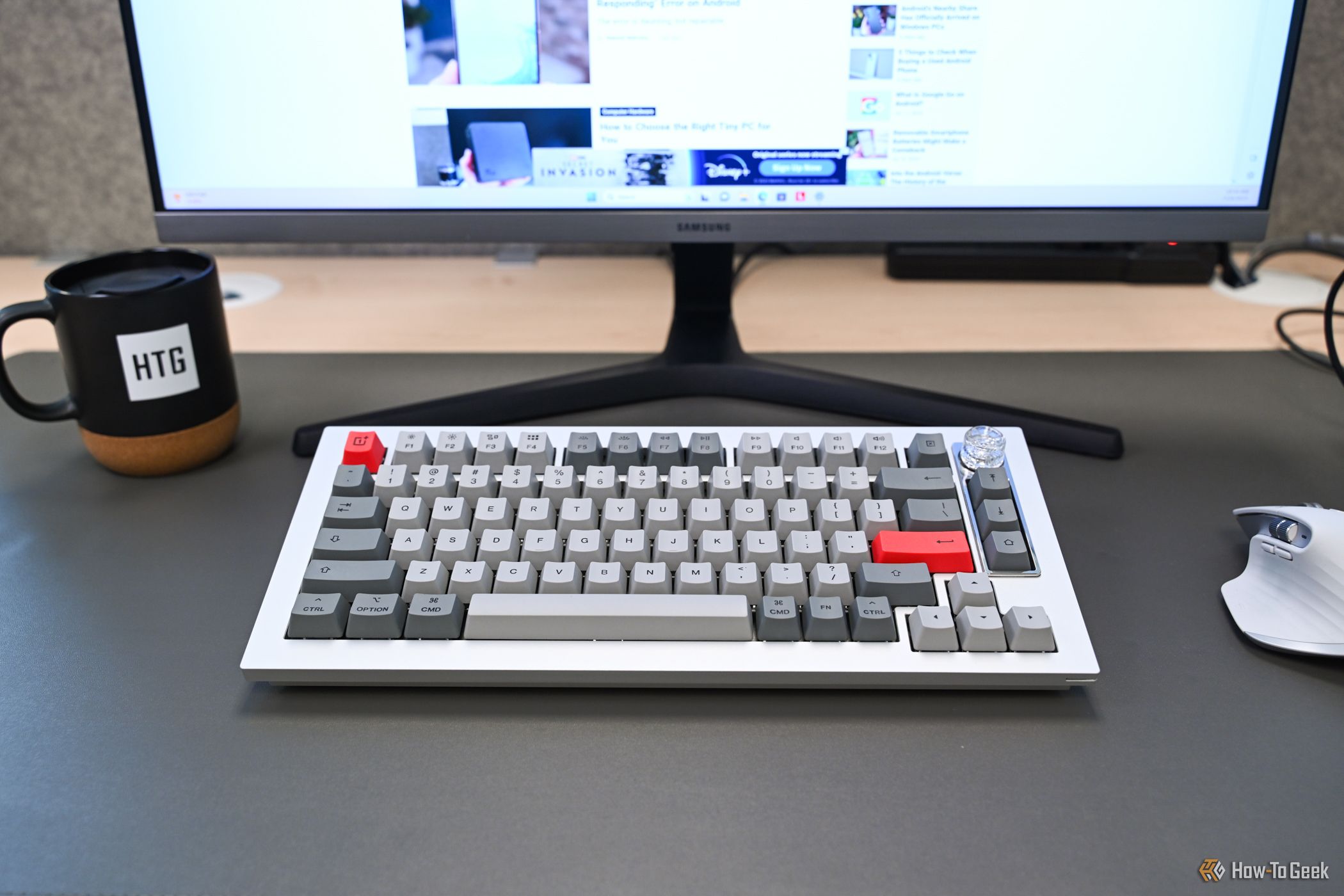 Showing OnePlus Keyboard 81 Pro on a desk in front of a monitor