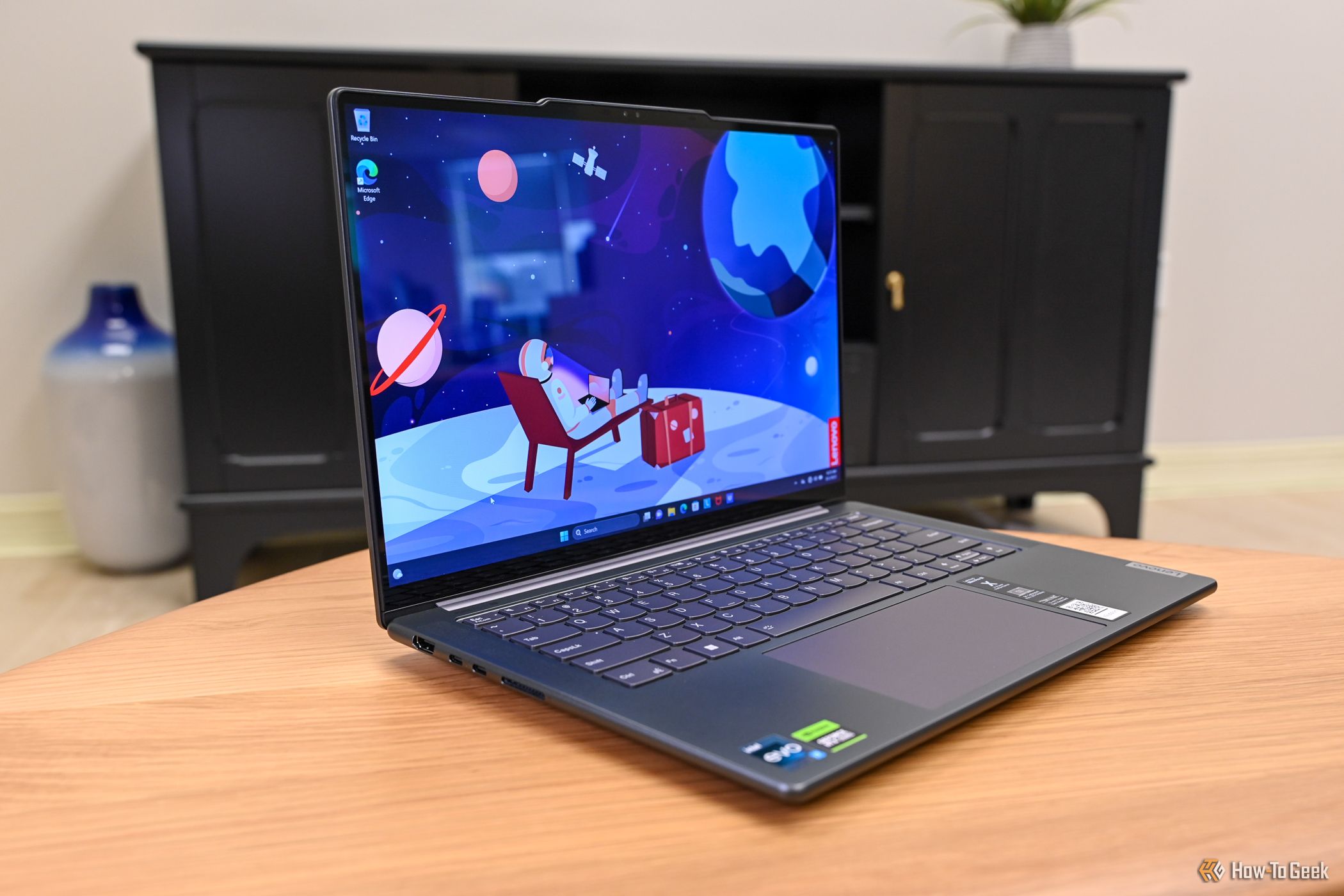 A Lenovo Slim Pro 9i 14 Gen 8 open on a coffee table 3.