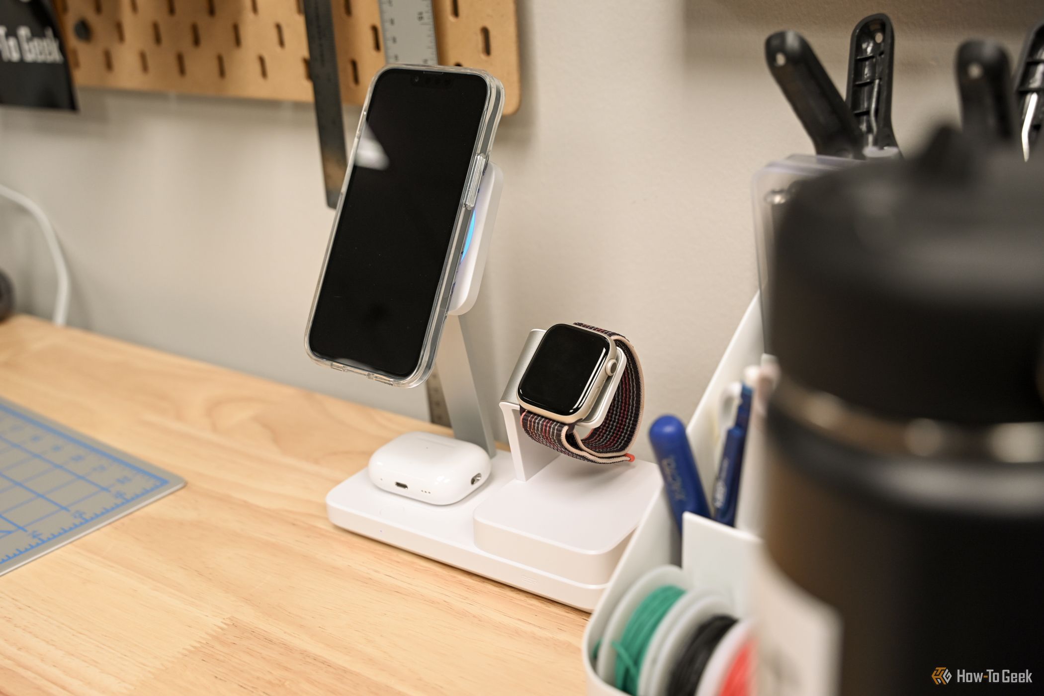 An iPhone, AirPods, and Apple Watch charging on the ESR 100W 6-in-1 Charging Station.