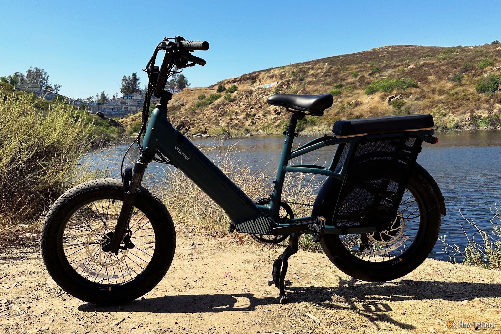Showing the Velotric Go 1 standing in front of a body of water