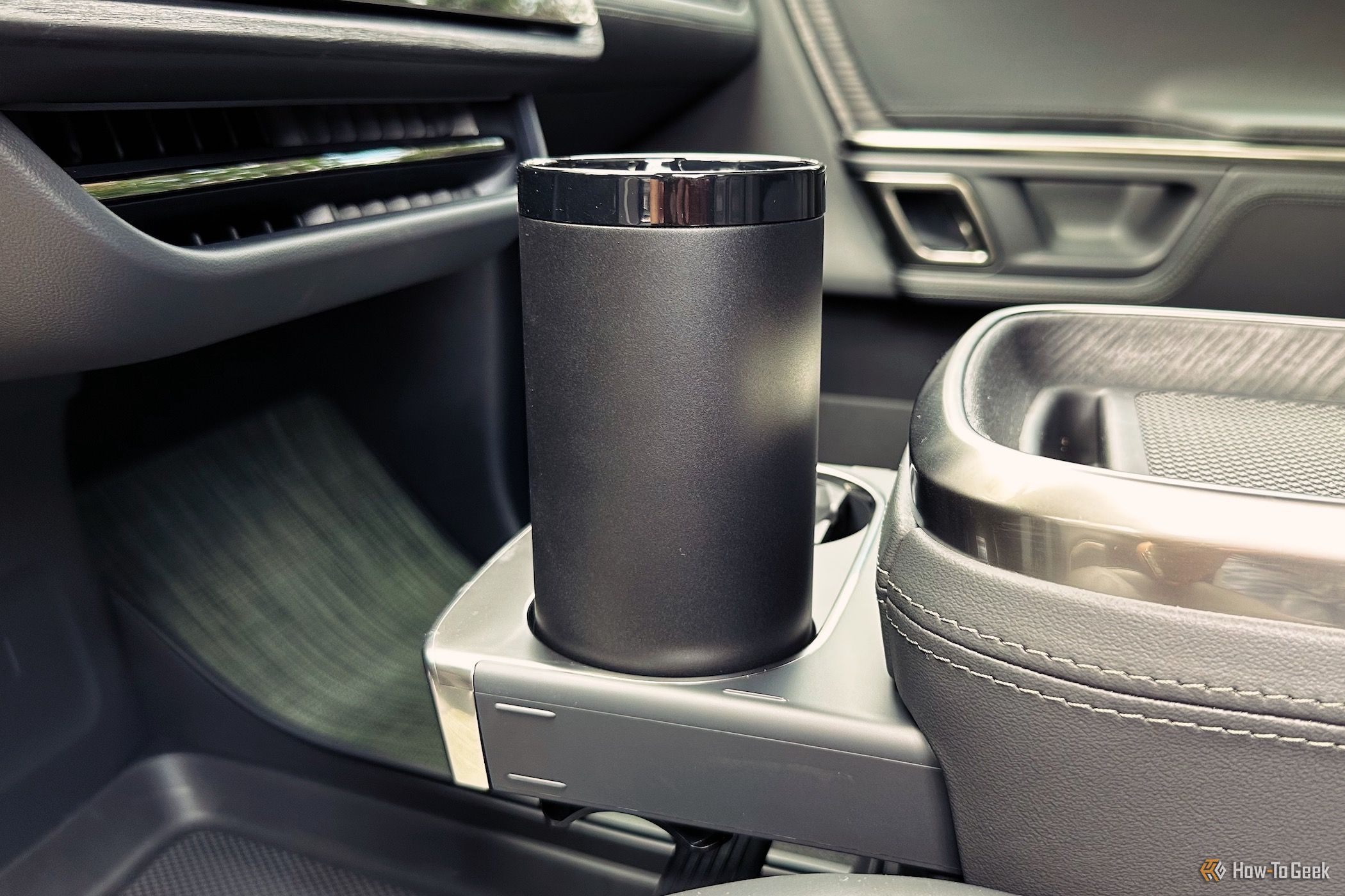 Showing the Ember Tumbler sitting in a car's cup holder.