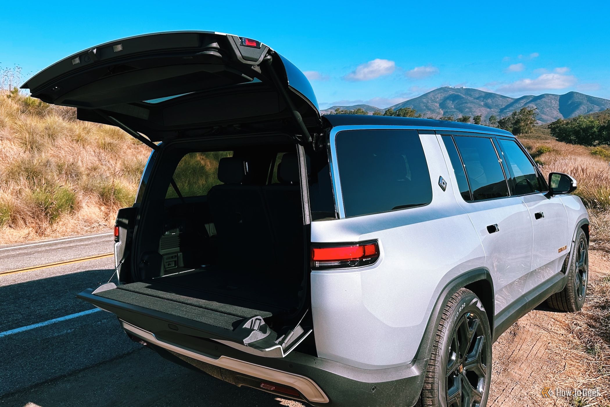 Rivian R1S from the rear showing the trunk open