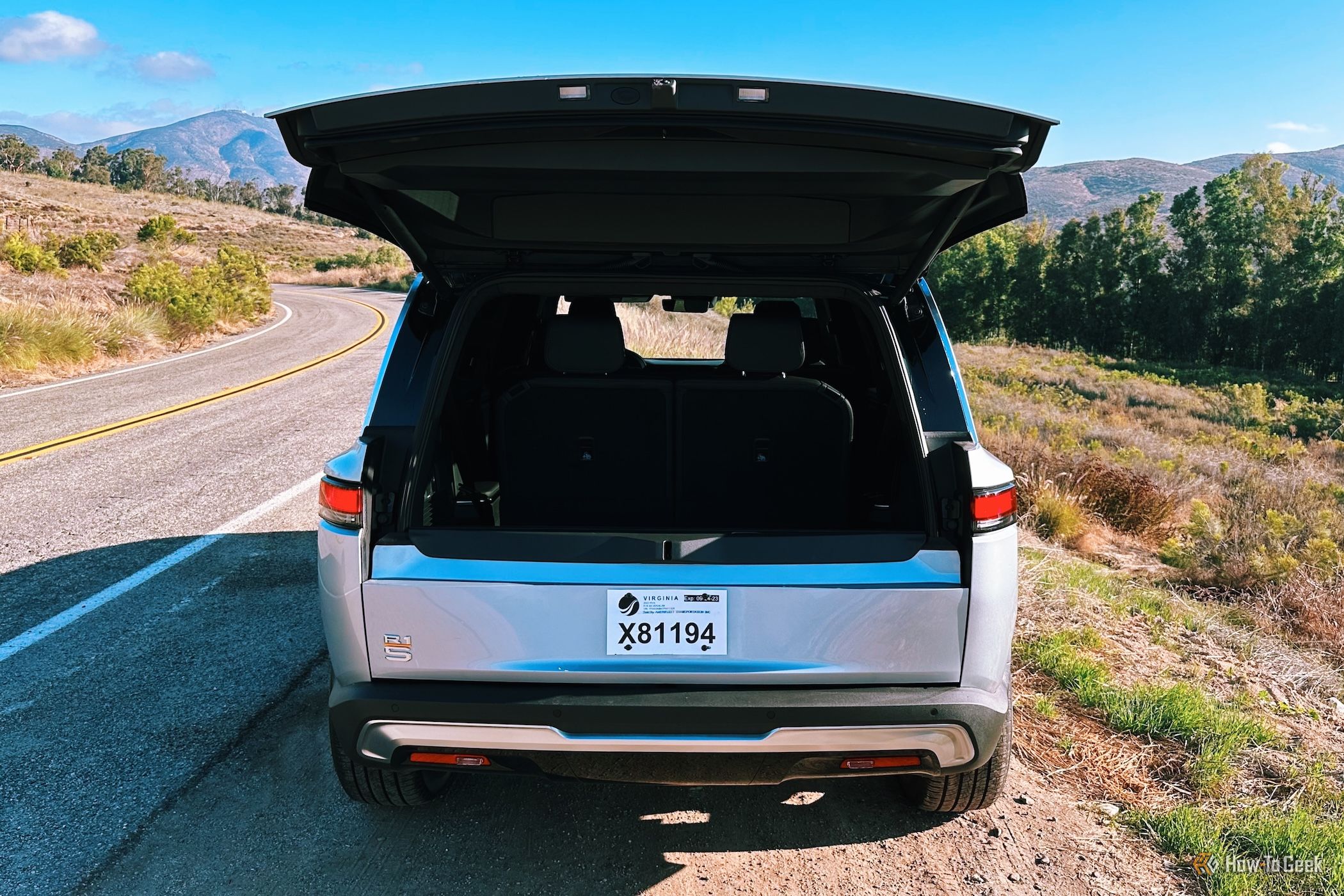 Rivian R1S with the top lift gate open and the bottom portion closed