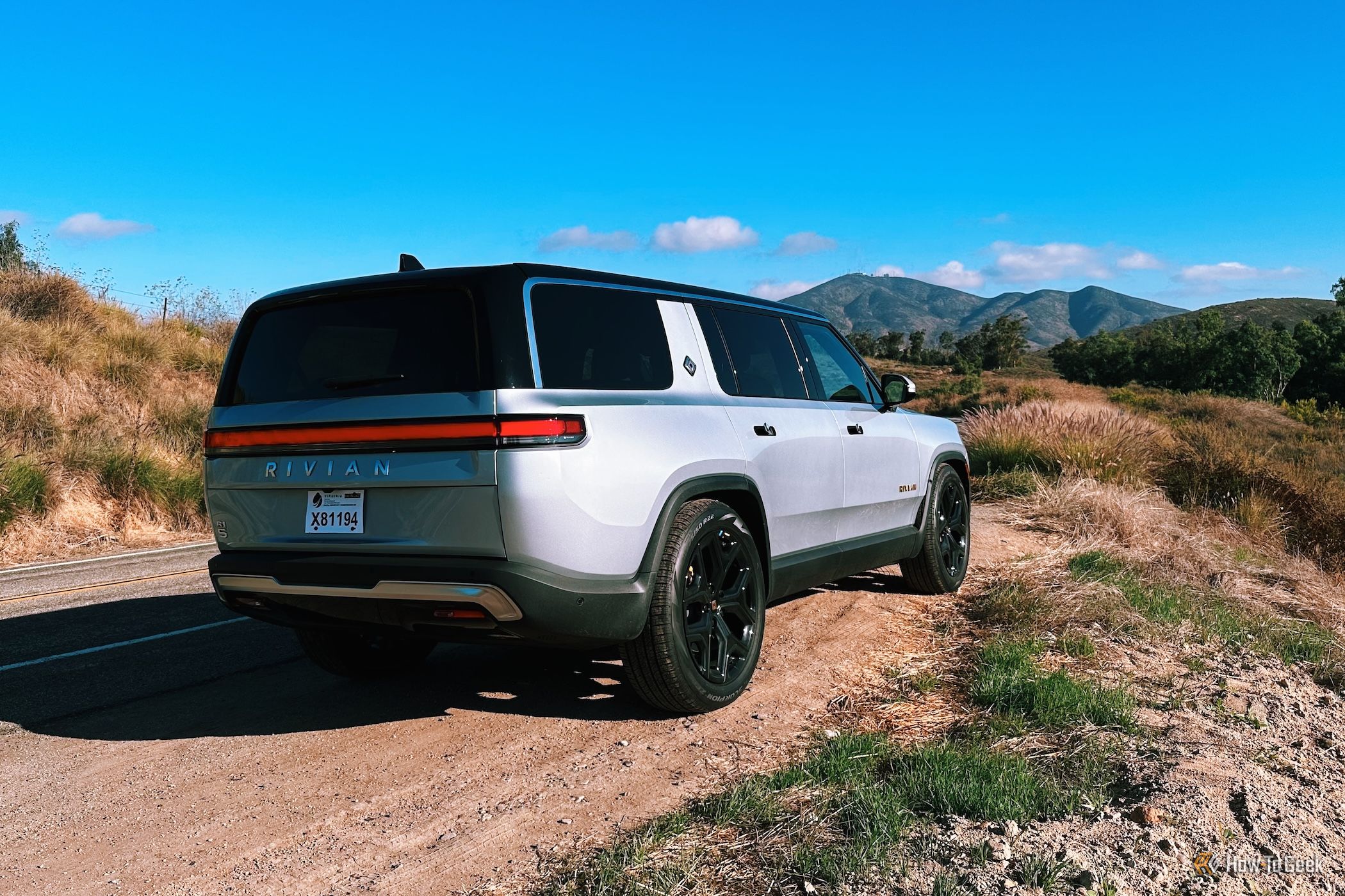 Rivian R1S in silver facing away from view